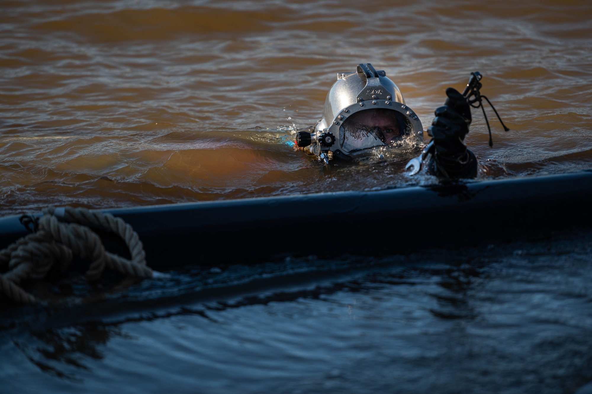 A U.S. Army Soldier dives during a simulated contaminated water diving field training exercise.