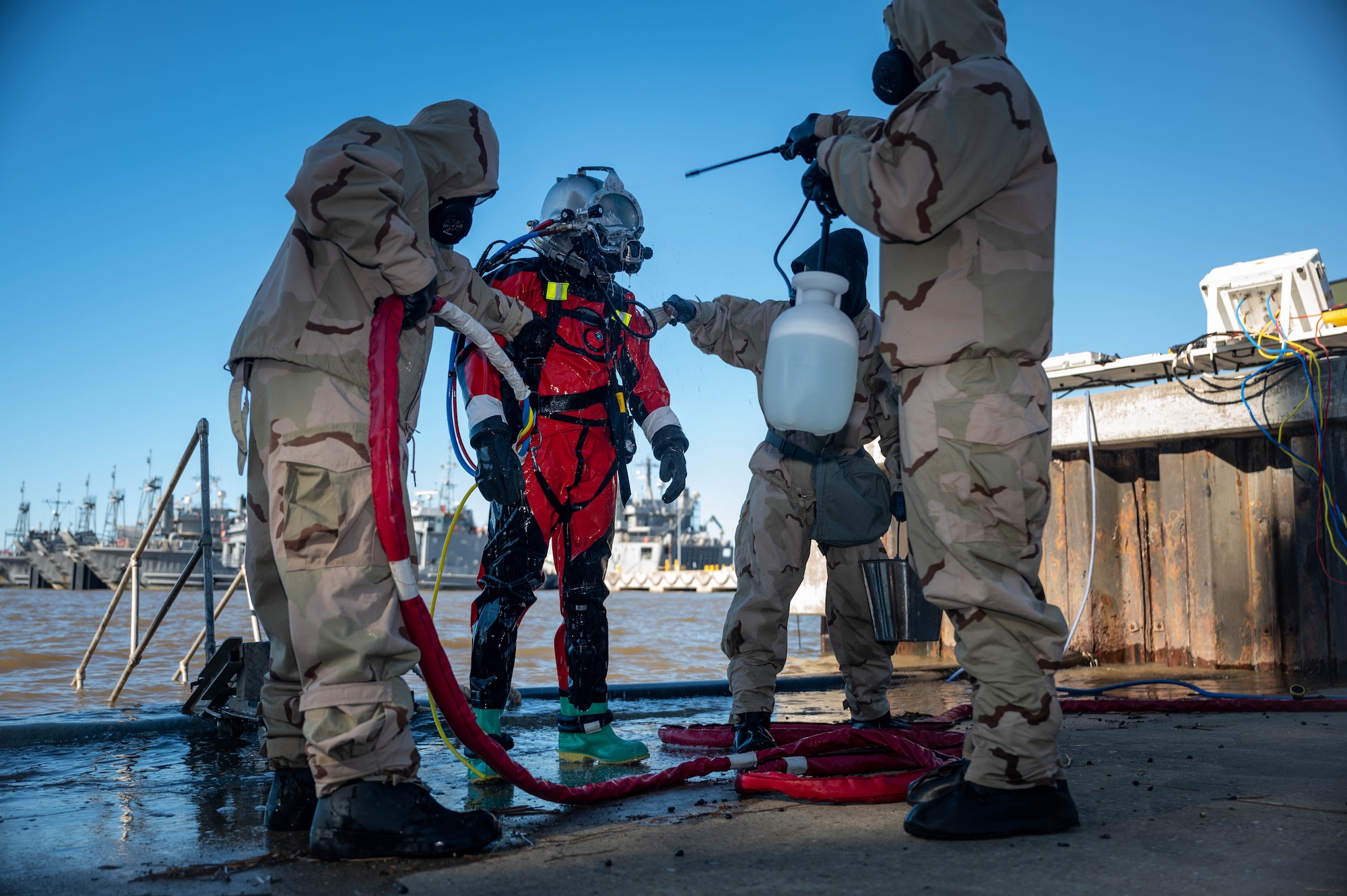A U.S. Army Soldier goes through a decontamination process after a simulated contaminated water diving field training exercise.
