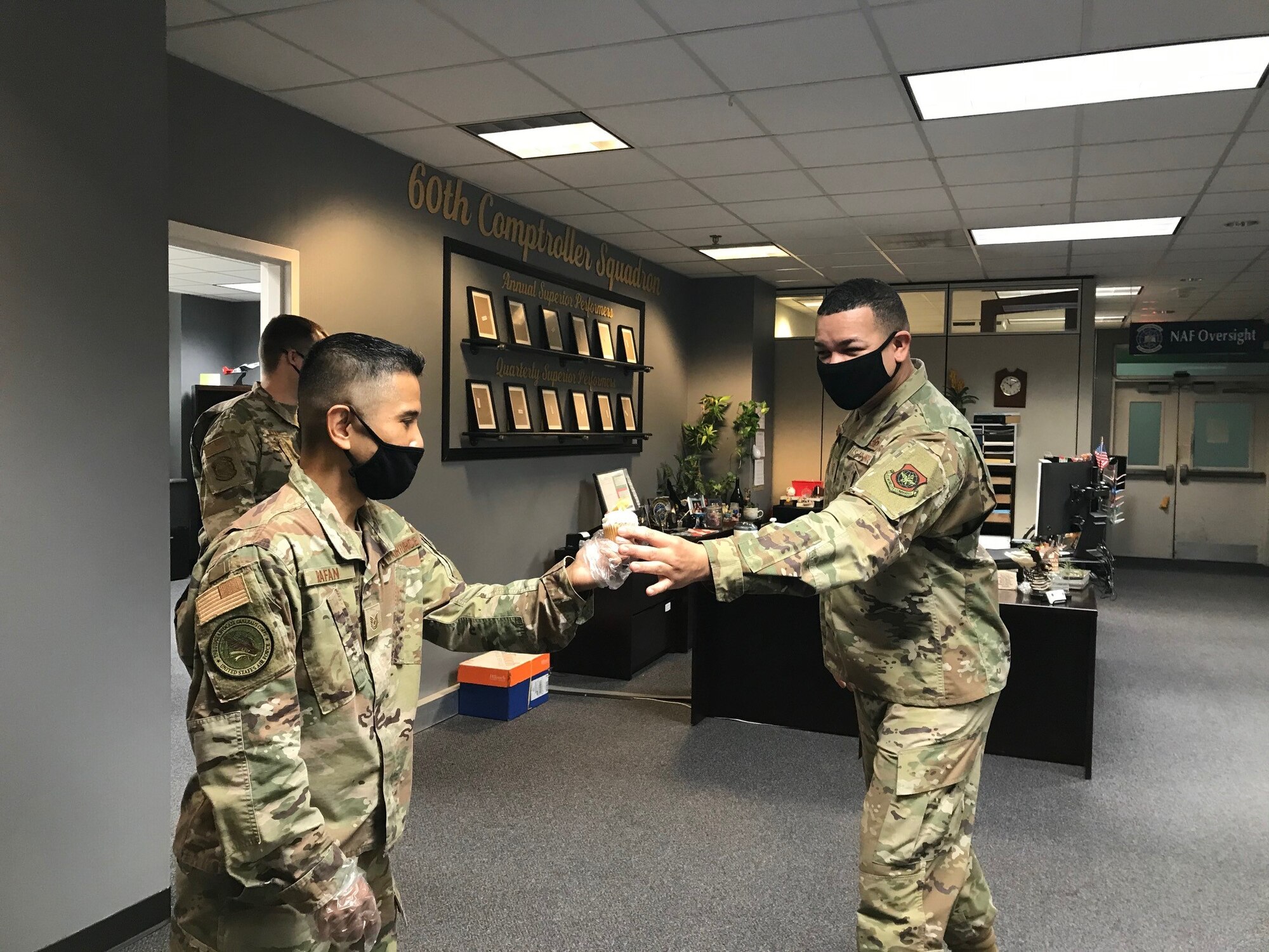 Male service members in an office building.