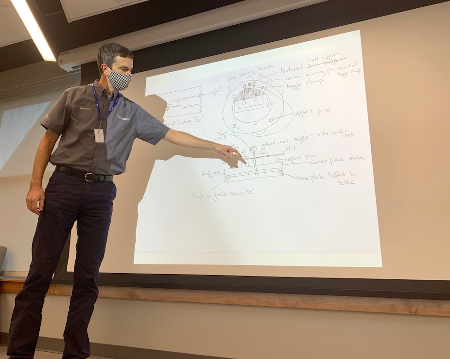 Tyler Rourke with Electroimpact, out of Washington state, showcases a sketch of his prototype to solve drilling B-52 brakes during a Design Sprint held at STRIKEWERX in Bossier City, La., Nov. 16-19, 2020.