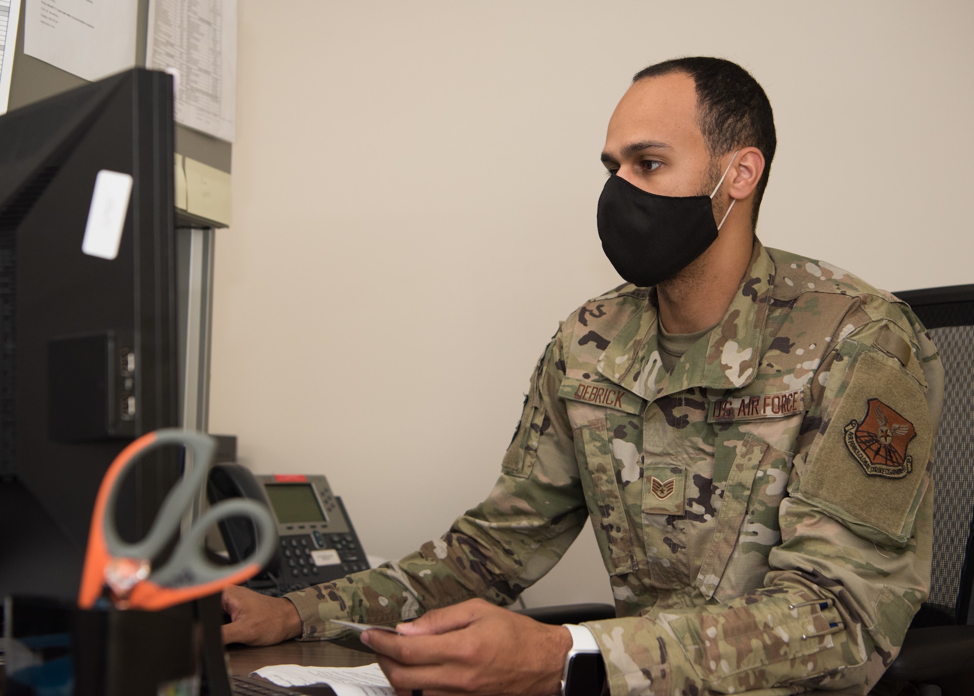 U.S. Air Force Staff Sgt. Bradley Debrick, 509th Medical Operations Squadron immunizations technician, works on his computer in the immunizations clinic.