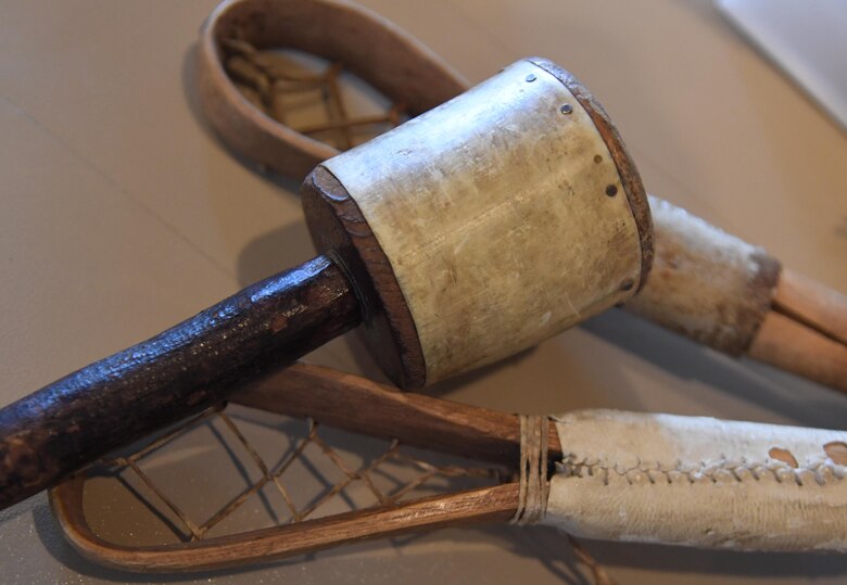 A rattle and stick ball sticks are displayed during a Native American History Month story telling event inside the Bay Breeze Event Center at Keesler Air Force Base, Mississippi, Nov. 19, 2020. GrayHawk Perkins visited Keesler to share his story about his life growing up as a Native American in celebration of Native American History Month. (U.S. Air Force photo by Kemberly Groue)