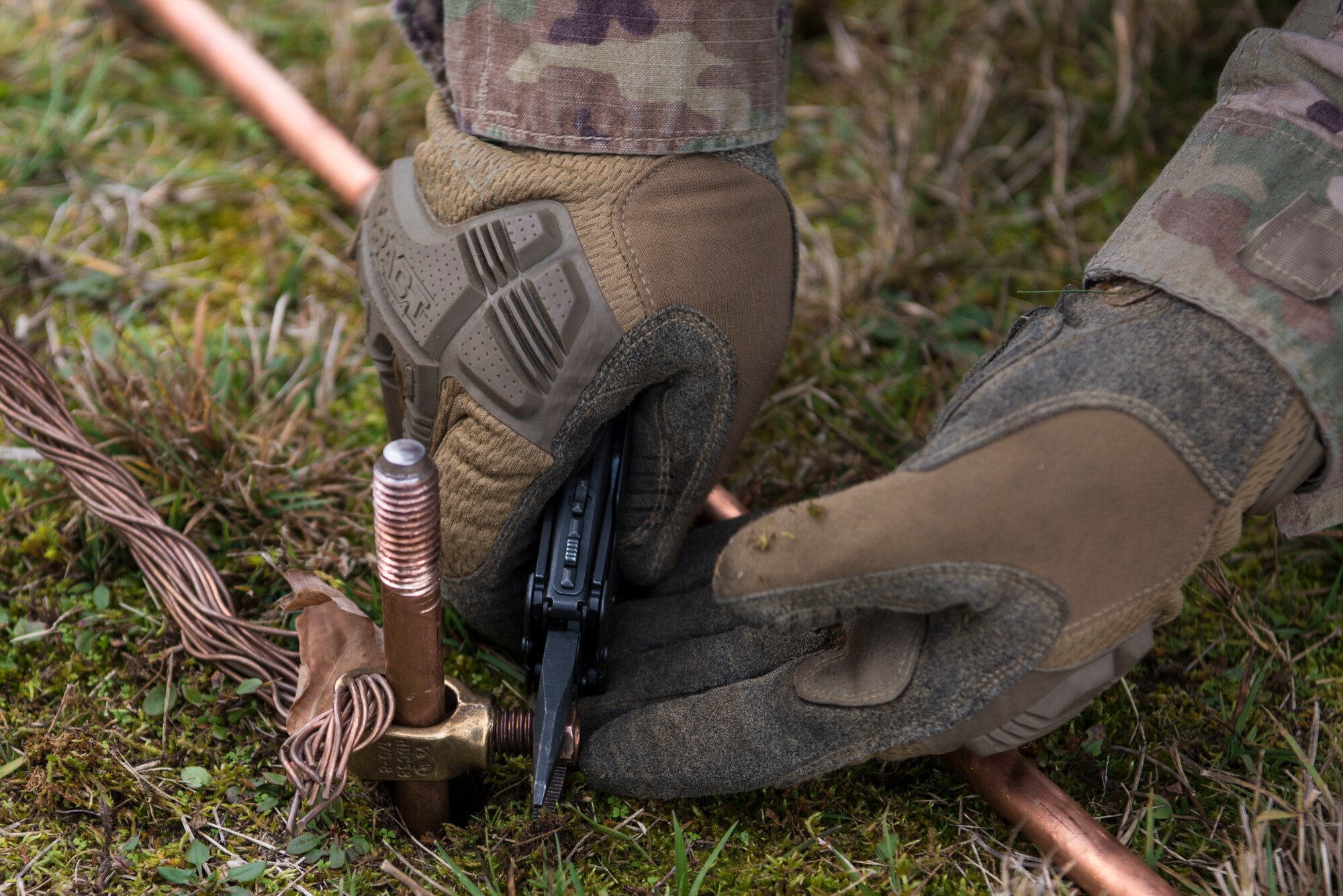 A U.S. Airman assigned to the 435th Contingency Response Group tightens and grounds an electrical coil for a base build-up during exercise Agile Wolf 21-01