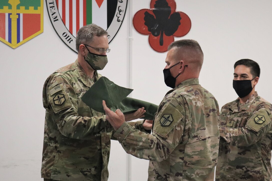 Col. Derek Ulehla and Command Sgt. Maj. James Marsh case the 301st Maneuver Enhancement Brigade colors after the transfer of authority ceremony for Area Support Group-Jordan. The 301st MEB mobilized to Jordan in March to provide support operations for U.S. forces in Jordan. The U.S. military is in Jordan to partner with the Jordan Armed Forces to meet common security objectives in the region.