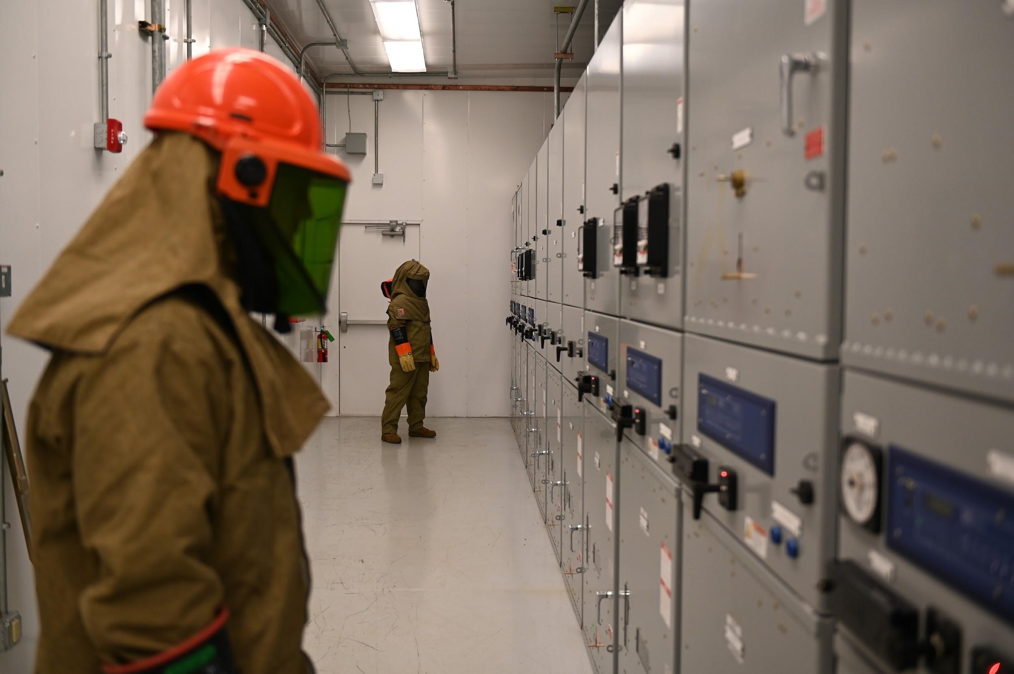 Senior Airman Taylor Trenton, 87th Civil Engineering Squadron electrical systems journeyman, and Airman 1st Class Eva Enevidas, 87th CES electrical systems apprentice, prepare to shut down electrical power on Joint Base McGuire-Dix-Lakehurst as part of the Energy Resiliency Readiness Exercise, Nov. 19, 2020. The ERRE serves as a method of testing the resilience posture of an installation’s energy, water and communication networks, while identifying performance gaps and vulnerabilities in key assets. (U.S. Air Force photo by Airman 1st Class Joseph Morales)