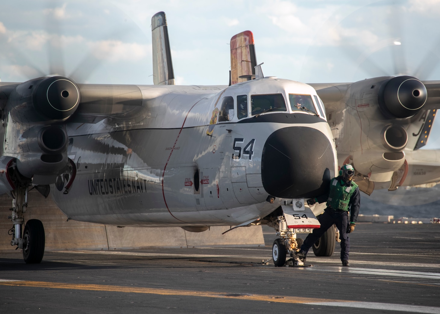A Sailor prepares a C-2A Greyhound attached to the "Rawhides" of Fleet Logistics Support Squadron (VRC) 40 to launch during cyclic flight operations, Nov. 17, 2020.