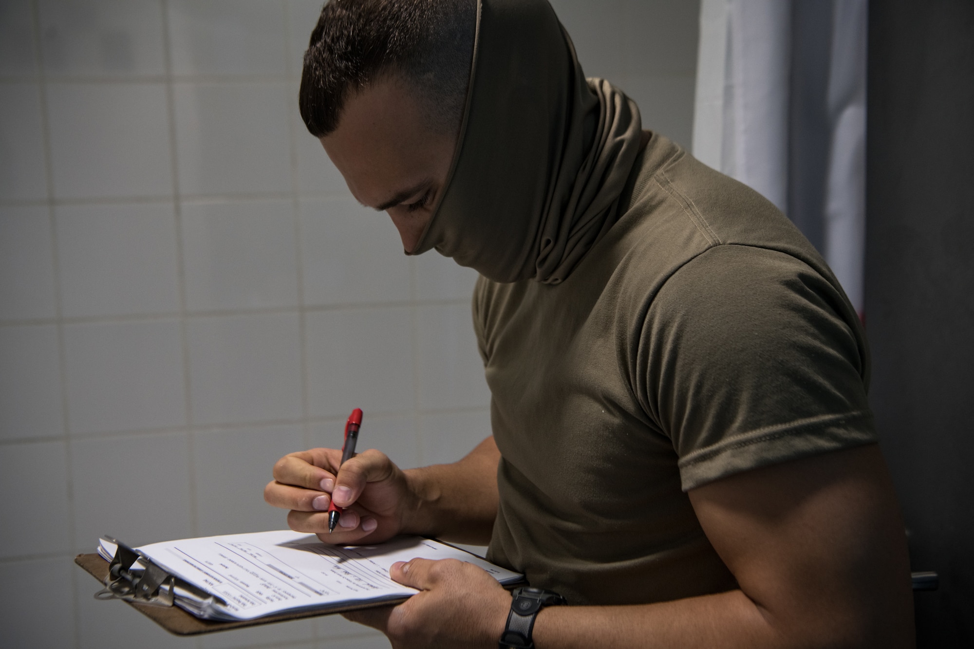 Staff Sgt. Levi Barnett, a water and fuels system maintenance specialist with the 379th Expeditionary Civil Engineer Squadron facility management team, fills out a task list Nov. 3, 2020, at Al Udeid Air Base, Qatar. The 379th ECES facility management team has been tasked to address minor maintenance issues in every dorm building on base, improving the quality of life for service members stationed at AUAB. (U.S. Air National Guard photo by Tech. Sgt. Brigette Waltermire)