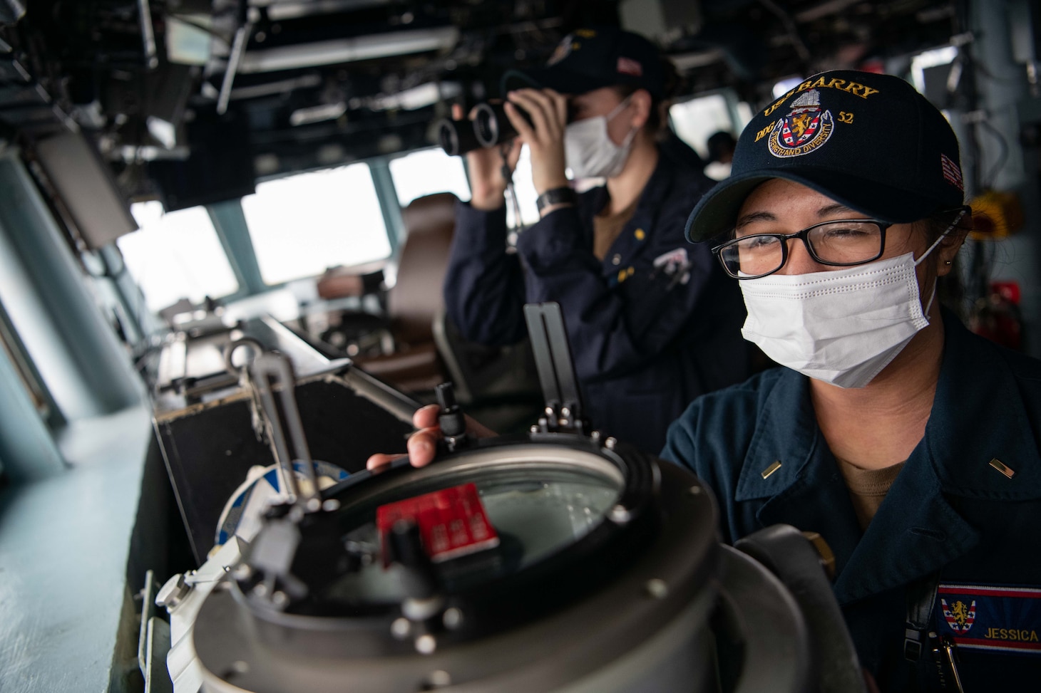 TAIWAN STRAIT (Nov. 20, 2020) – Ensign Jessica Cruz, from Virginia Beach, Va., shoots a line of bearing on the bridge of the guided-missile destroyer USS Barry (DDG 62) as the ship conducts routine underway operations in the Taiwan Strait. Barry is assigned to Destroyer Squadron (DESRON) 15, the Navy’s largest forward-deployed DESRON and the U.S. 7th Fleet's principal surface force, forward-deployed to the U.S. 7th Fleet area of operations in support of a free and open Indo-Pacific. (U.S. Navy photo by Lieutenant Junior Grade Samuel Hardgrove)