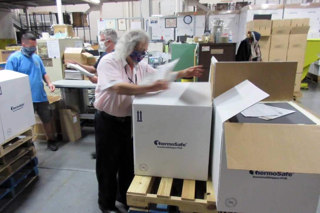 A man inspects a shipment of goods.