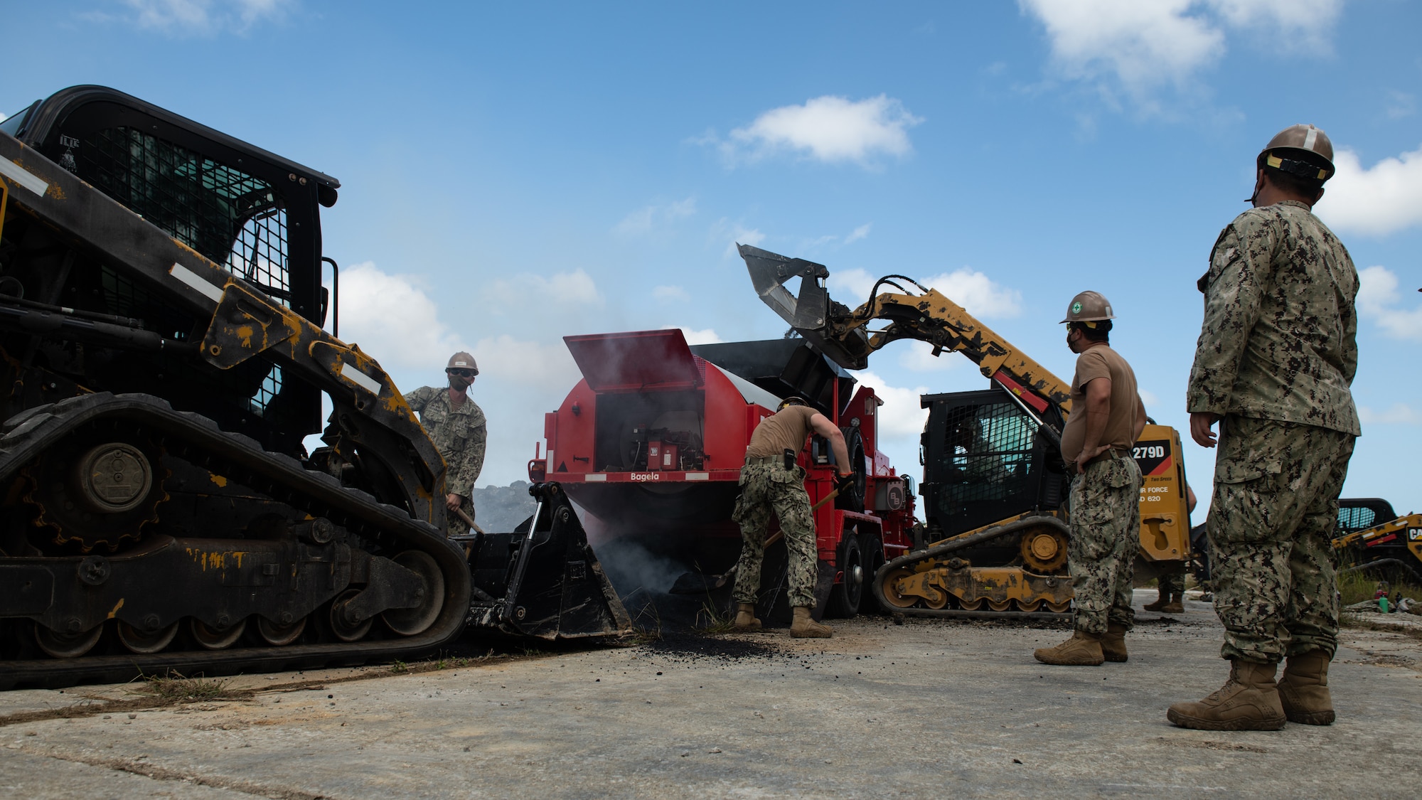 U.S. Air Force 18th Civil Engineer Squadron Airmen and Navy Mobile Construction Battalion 3 Seabees recycle asphalt during a rapid airfield damage repair exercise Nov. 18, 2020, at Kadena Air Base, Japan. The joint training enabled the two units to synchronize training, tactics and procedures for RADR operations. (U.S. Air Force photo by Staff Sgt. Peter Reft)