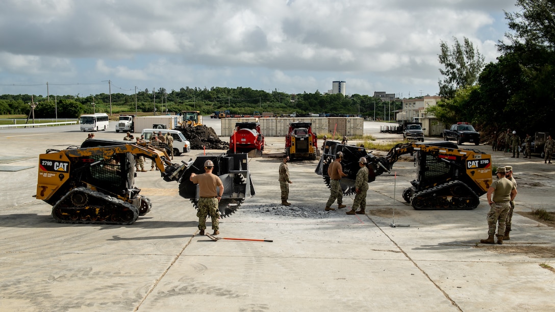 U.S. Air Force 18th Civil Engineer Squadron Airmen and Navy Mobile Construction Battalion 3 Seabees conduct a rapid airfield damage repair exercise Nov. 18, 2020, at Kadena Air Base, Japan. Units throughout the U.S. Indo-Pacific Command theater conduct regular joint training in order to strengthen partnerships and interoperability. (U.S. Air Force photo by Staff Sgt. Peter Reft)