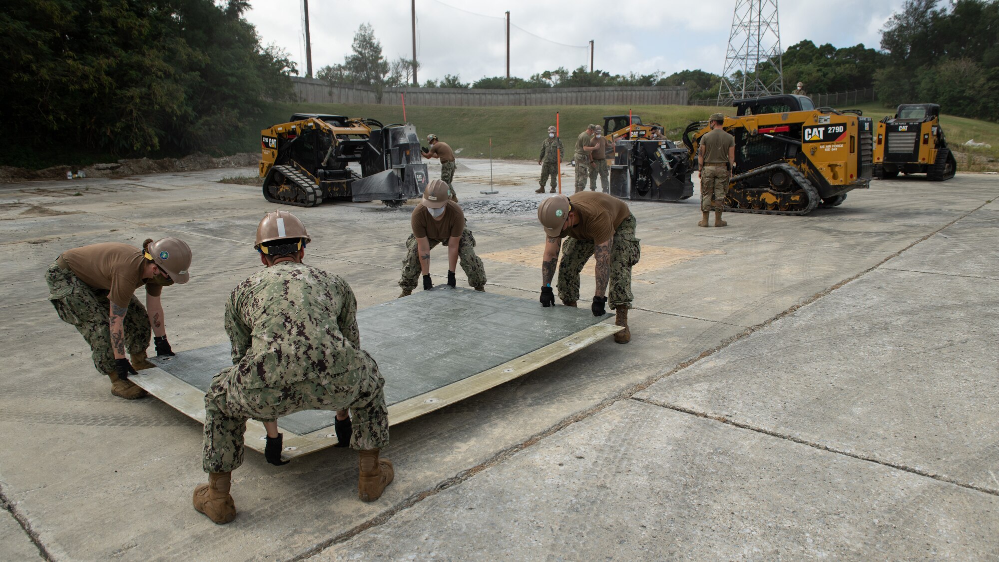 U.S. Air Force 18th Civil Engineer Squadron Airmen and Navy Mobile Construction Battalion 3 Seabees conduct a rapid airfield damage repair exercise Nov. 18, 2020, at Kadena Air Base, Japan. In order to adapt to constantly changing Pacific Theater mission demands, Department of Defense units throughout the U.S. Indo-Pacific Command theater train together in order to innovate training operations and enhance agile force employment capabilities. (U.S. Air Force photo by Staff Sgt. Peter Reft)