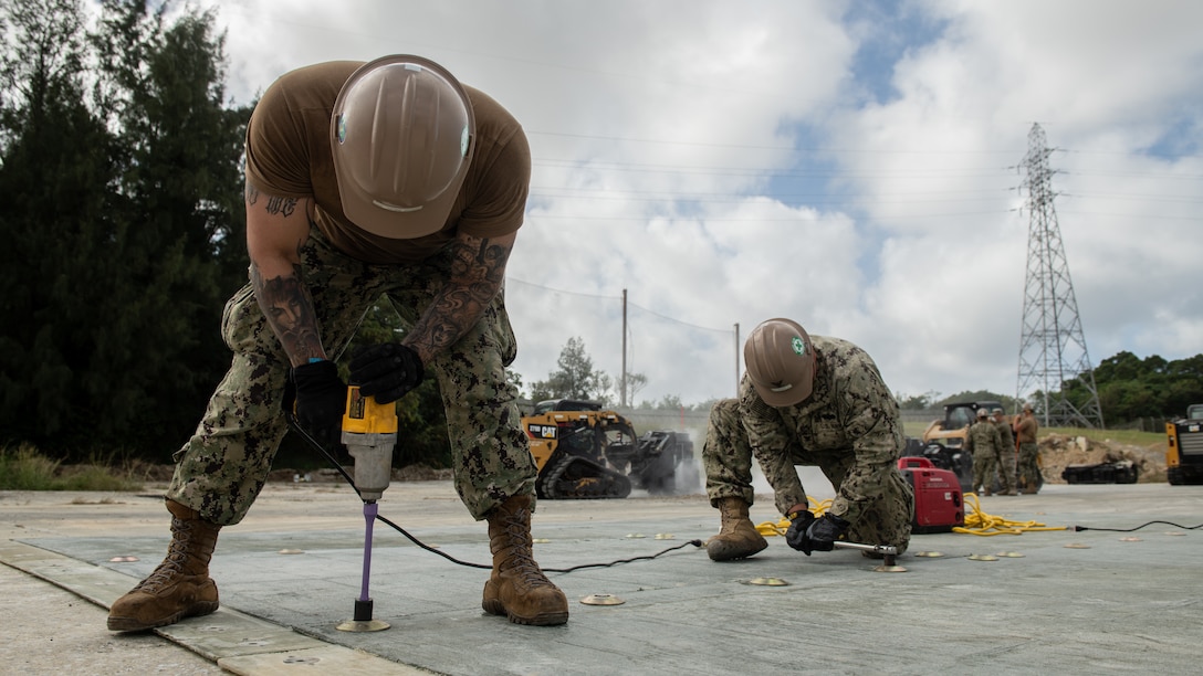 U.S. Navy Mobile Construction Battalion 3 Seabees secure fiberglass panels together during a rapid airfield damage repair exercise Nov. 18, 2020, at Kadena Air Base, Japan. NMCB-3 is deployed across the Indo-Pacific region conducting high-quality construction to support U.S. and partner nations to strengthen partnerships, deter aggression, and enable expeditionary logistics and naval power projection. The battalion stands ready to complete assigned tasking, support Humanitarian Aid/Disaster Relief and Major Combat Operations throughout the area of responsibility. (U.S. Air Force photo by Staff Sgt. Peter Reft)