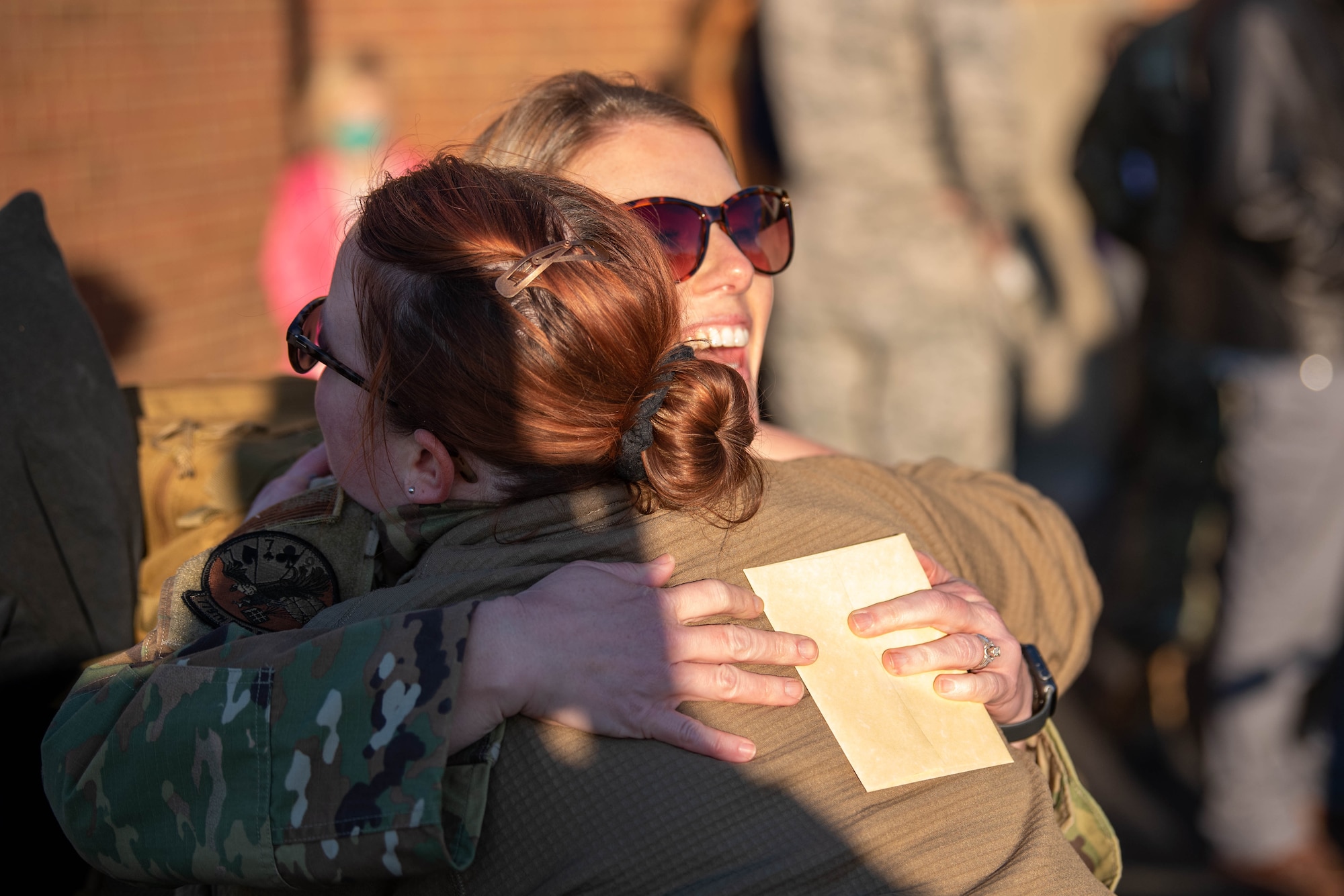 Two Airmen from the 123rd Airlift Wing embrace during a homecoming where more than 90 Airmen from the Kentucky Air National Guard returned to their home base in Louisville, Ky., Nov. 18, 2020, after completing a four-month deployment to the Middle East. The Airmen, who arrived aboard Kentucky Air Guard C-130 Hercules aircraft, operated from an undisclosed air base while flying troops and cargo across the U.S. Central Command Area of Responsibility in support of Operations Inherent Resolve and Freedom’s Sentinel. (U.S. Air National Guard photo by Phil Speck)