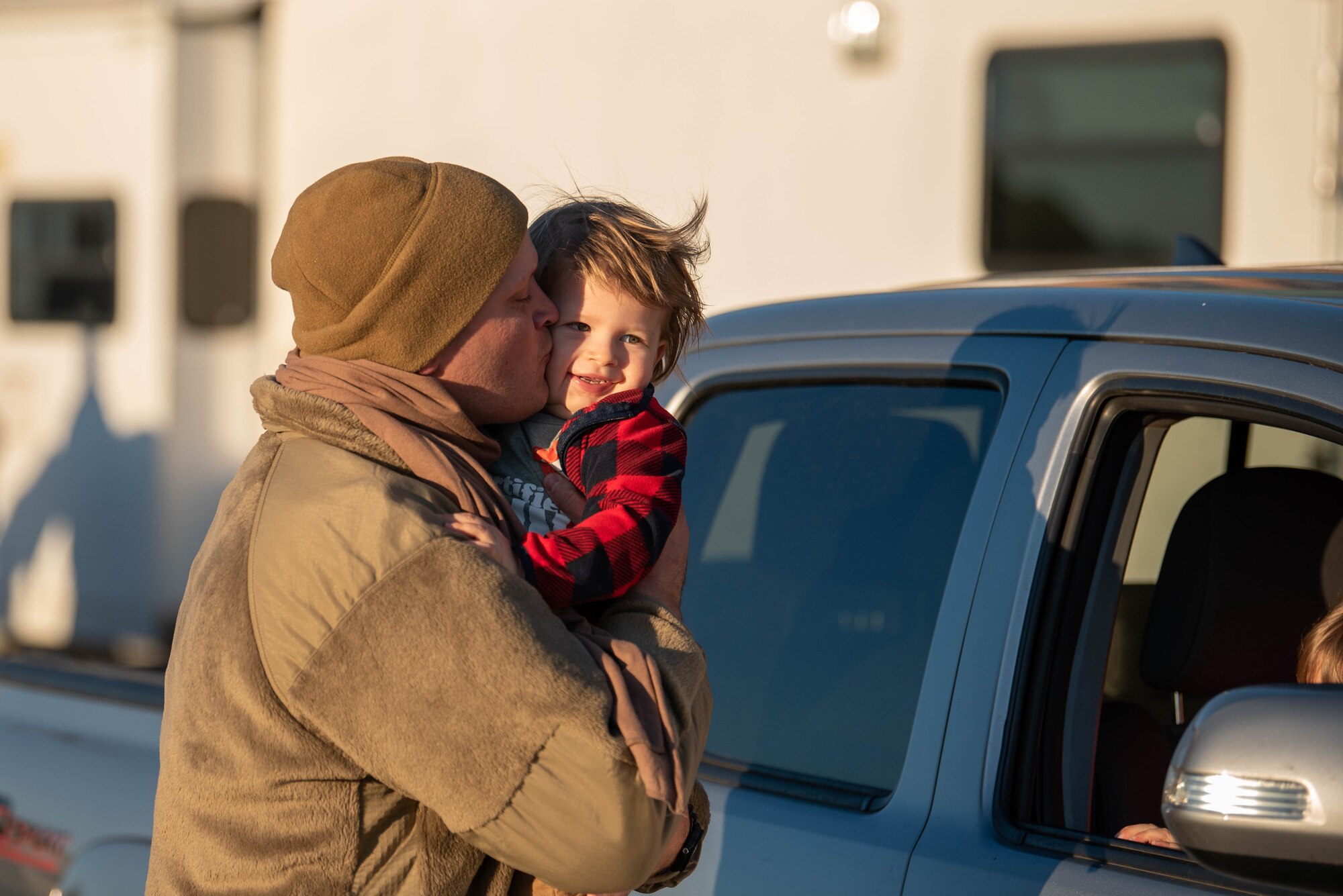 Capt. Jason Ketterer, a navigator for the 165th Airlift Squadron, is greeted by his family at the Kentucky Air National Guard base in Louisville, Ky., on Nov. 18, 2020, after completing a four-month deployment to the Middle East in support of Operations Inherent Resolve and Freedom’s Sentinel. More than 90 Airmen from the 123rd Airlift Wing arrived aboard Kentucky Air Guard C-130 Hercules aircraft. (U.S. Air National Guard photo by Phil Speck)