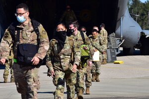Airmen assigned to the 628th Air Base Wing disembark from a C-17 Globemaster III to begin training for Palmetto Challenge, at McEntire Joint National Guard Base, S.C.,  Nov. 16, 2020. Palmetto Challenge is a global mobilization exercise held at McEntire Joint National Guard Base, S.C. The exercise is held in order to develop readiness and awareness in a simulated deployed environment for over 100 Airmen from Joint Base Charleston.