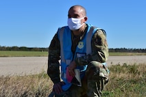 U.S. Air Force Tech. Sgt. Andrew Chilcoat, a 437th Airlift Wing Air Traffic Safety Electronics Personnel (ATSEP) evaluator, monitors as Airmen offload cargo from a C-17 Globemaster III at McEntire Joint National Guard Base, S.C., Nov. 16, 2020. Palmetto Challenge is a global mobilization exercise held at McEntire Joint National Guard Base, S.C. The exercise is held in order to develop readiness and awareness in a simulated deployed environment for over 100 Airmen from Joint Base Charleston.