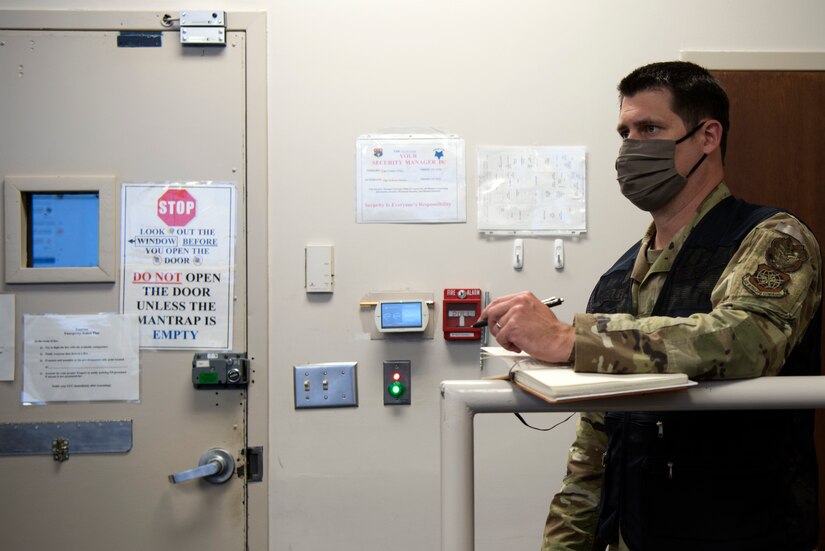 U.S. Air Force Master Sgt. Ian Ouellette, the superintendent for the 628th Air Base Wing Inspector General office, grades Airmen from the Emergency Operations Center (EOC) on how efficiently they equip Mission Oriented Protective Posture gear (MOPP), at McEntire Joint National Guard Base, S.C., Nov. 16, 2020. Palmetto Challenge is a global mobilization exercise held at McEntire Joint National Guard Base, S.C. The exercise is held in order to develop readiness and awareness in a simulated deployed environment for over 100 Airmen from Joint Base Charleston.