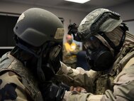 U.S. Air Force Capt. Alexander Arntz, a 315th Operations Support Intelligence (OSS) Wing Inspection Team (WIT) member, monitors Airmen from the Crisis Action Team (CAT), providing buddy checks at McEntire Joint National Guard Base, S.C., Nov. 16, 2020. Palmetto Challenge is a global mobilization exercise held at McEntire Joint National Guard Base, S.C., and Pope Army Airfield, N.C. The exercise is held in order to develop readiness and awareness in a simulated deployed environment for over 100 Airmen from Joint Base Charleston.