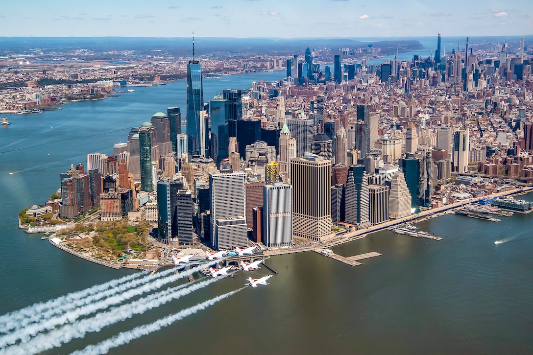 Air Force jets fly in formation by the Manhattan skyline.