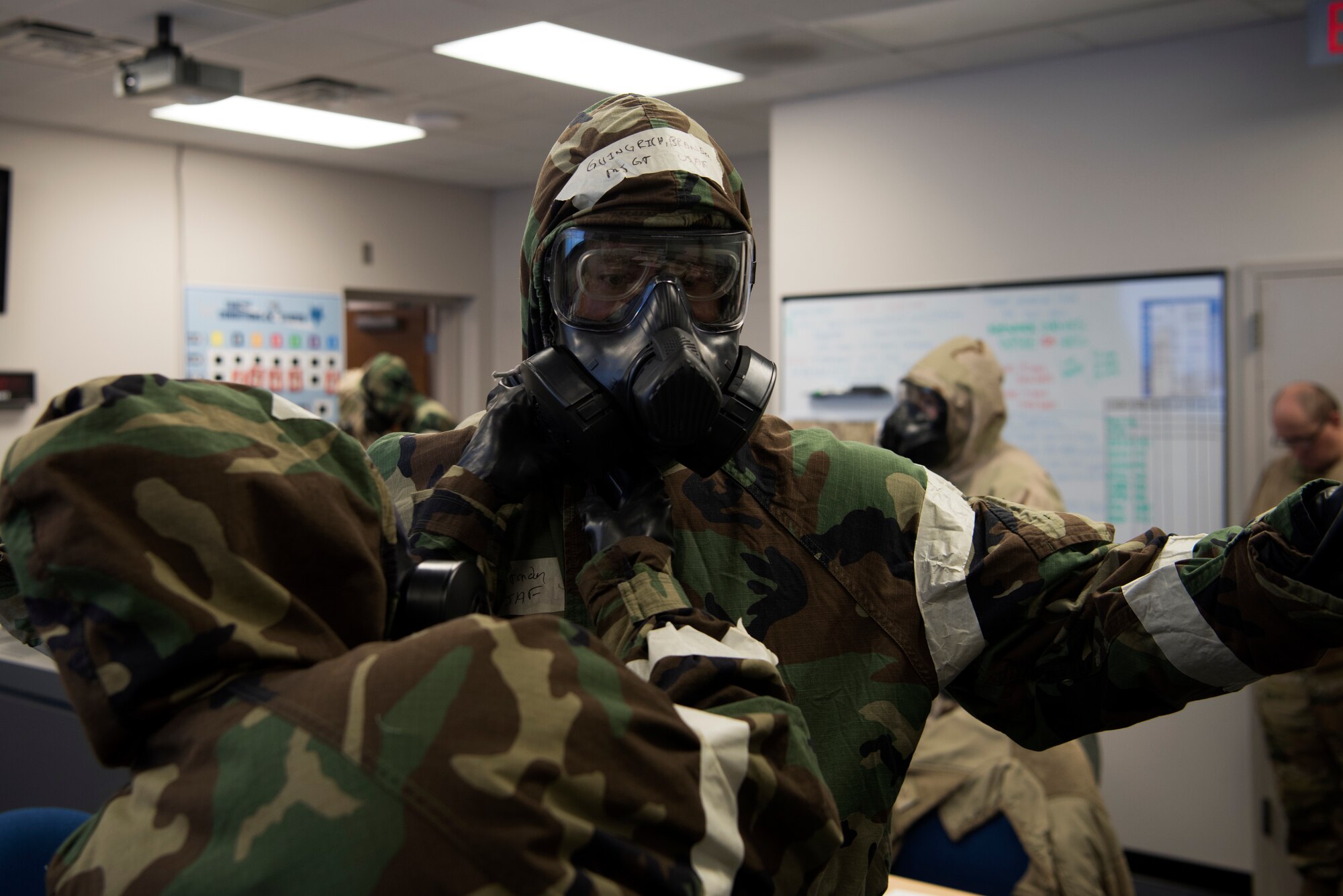 U.S. Air Force Master Sgt. Ian Ouellette, the superintendent for the 628th Air Base Wing Inspector General office, grades Airmen from the Emergency Operations Center (EOC) on how efficiently they equip Mission Oriented Protective Posture gear (MOPP), at McEntire Joint National Guard Base, S.C., Nov. 16, 2020. Palmetto Challenge is a global mobilization exercise held at McEntire Joint National Guard Base, S.C., and Pope Army Airfield, N.C. The exercise is held in order to develop readiness and awareness in a simulated deployed environment for over 100 Airmen from Joint Base Charleston.