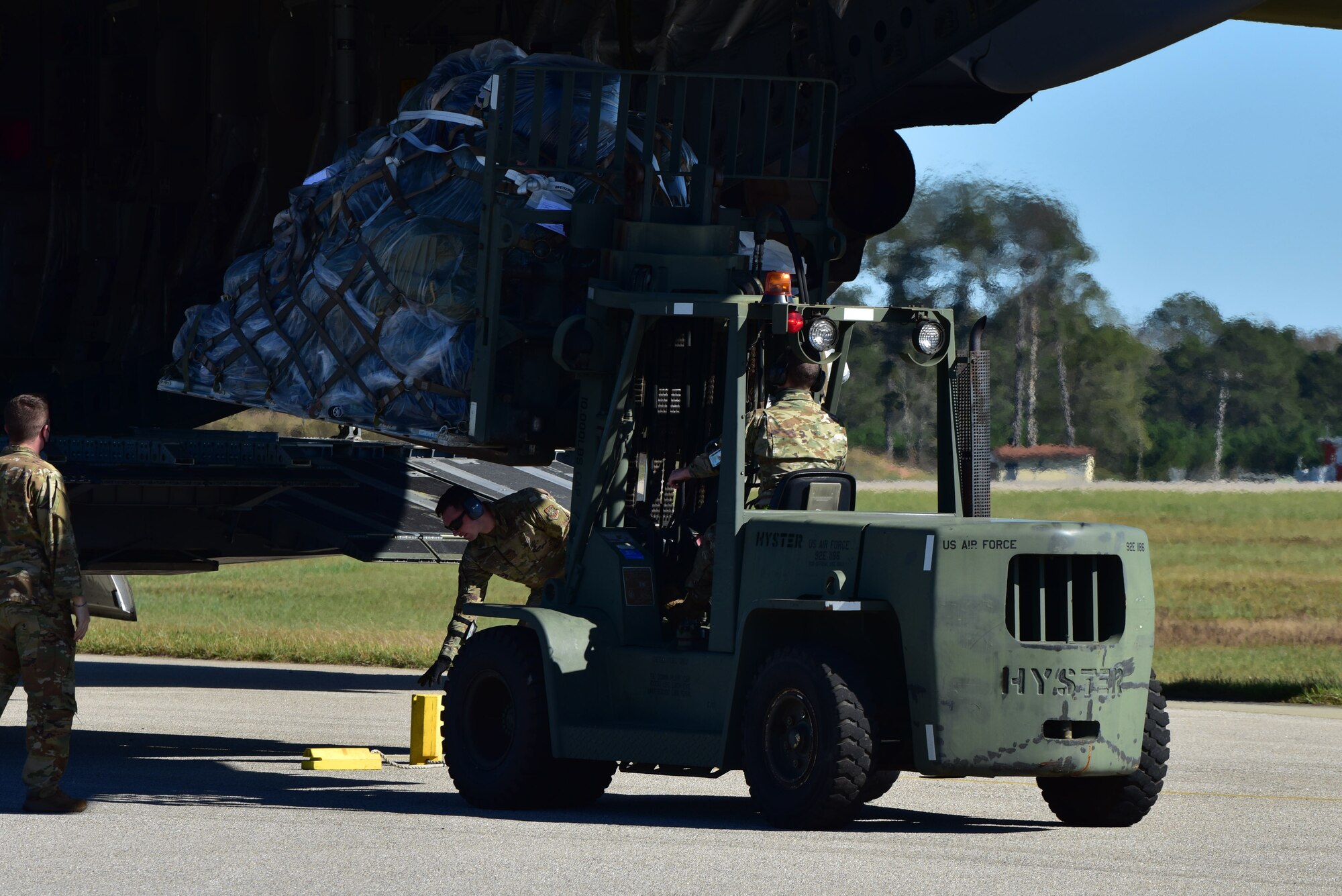 Airmen assigned to the 628th Air Base Wing begin to offload cargo from a C-17 Globemaster III at McEntire Joint National Guard Base, S.C., Nov. 16, 2020. Palmetto Challenge is a global mobilization exercise held at McEntire Joint National Guard Base, S.C., and Pope Army Airfield, N.C. The exercise is held in order to develop readiness and awareness in a simulated deployed environment for over 100 Airmen from Joint Base Charleston.