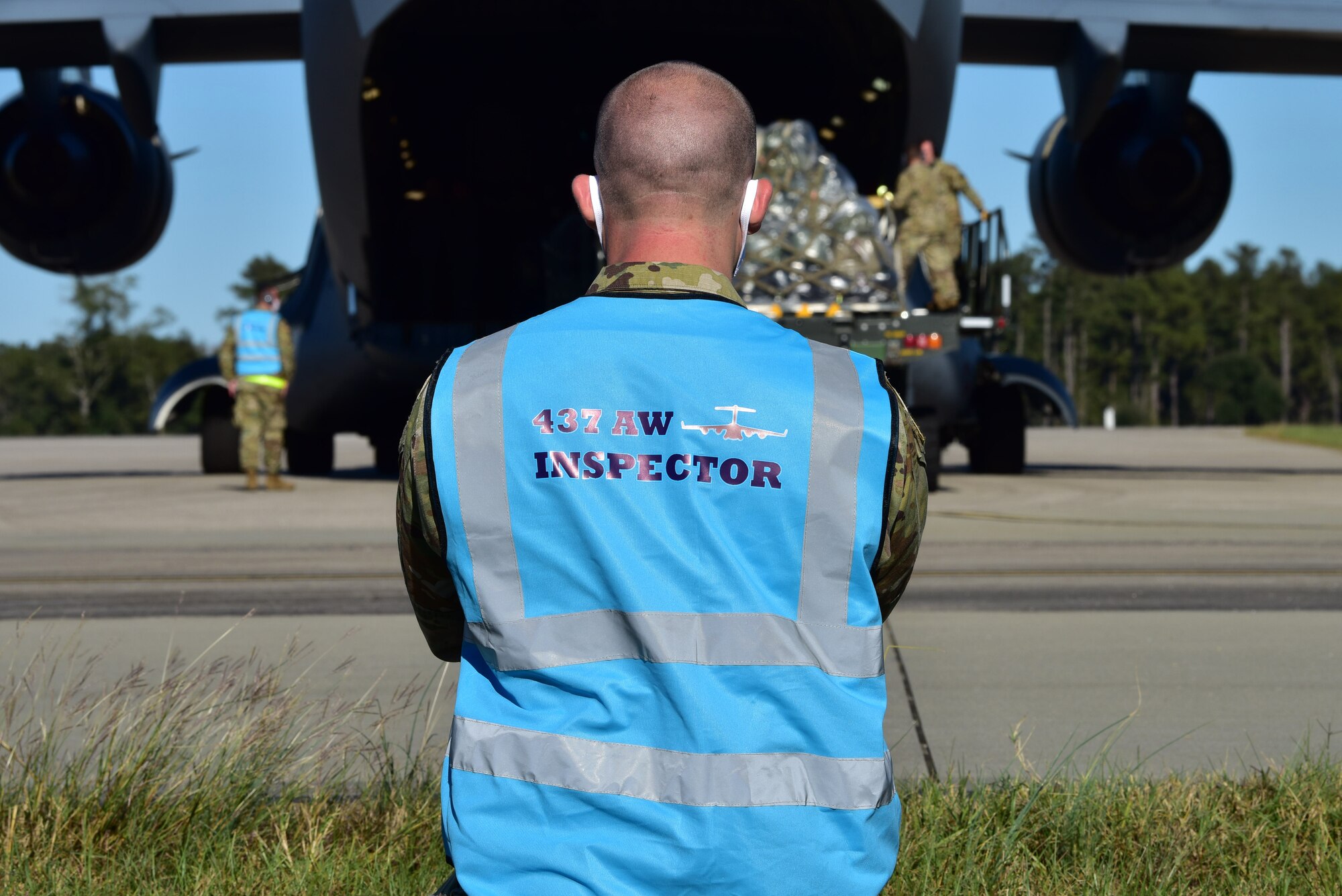 U.S. Air Force Tech. Sgt. Andrew Chilcoat, a 437th Airlift Wing Air Traffic Safety Electronics Personnel (ATSEP) evaluator, monitors as Airmen offload cargo from a C-17 Globemaster III at McEntire Joint National Guard Base, S.C., Nov. 16, 2020. Palmetto Challenge is a global mobilization exercise held at McEntire Joint National Guard Base, S.C., and Pope Army Airfield, N.C. The exercise is held in order to develop readiness and awareness in a simulated deployed environment for over 100 Airmen from Joint Base Charleston.