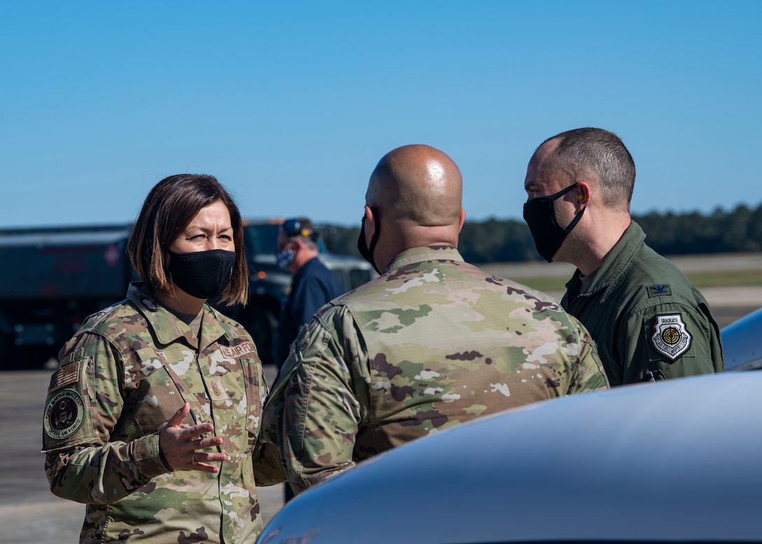 A photo of Airmen conversing on the flightline.