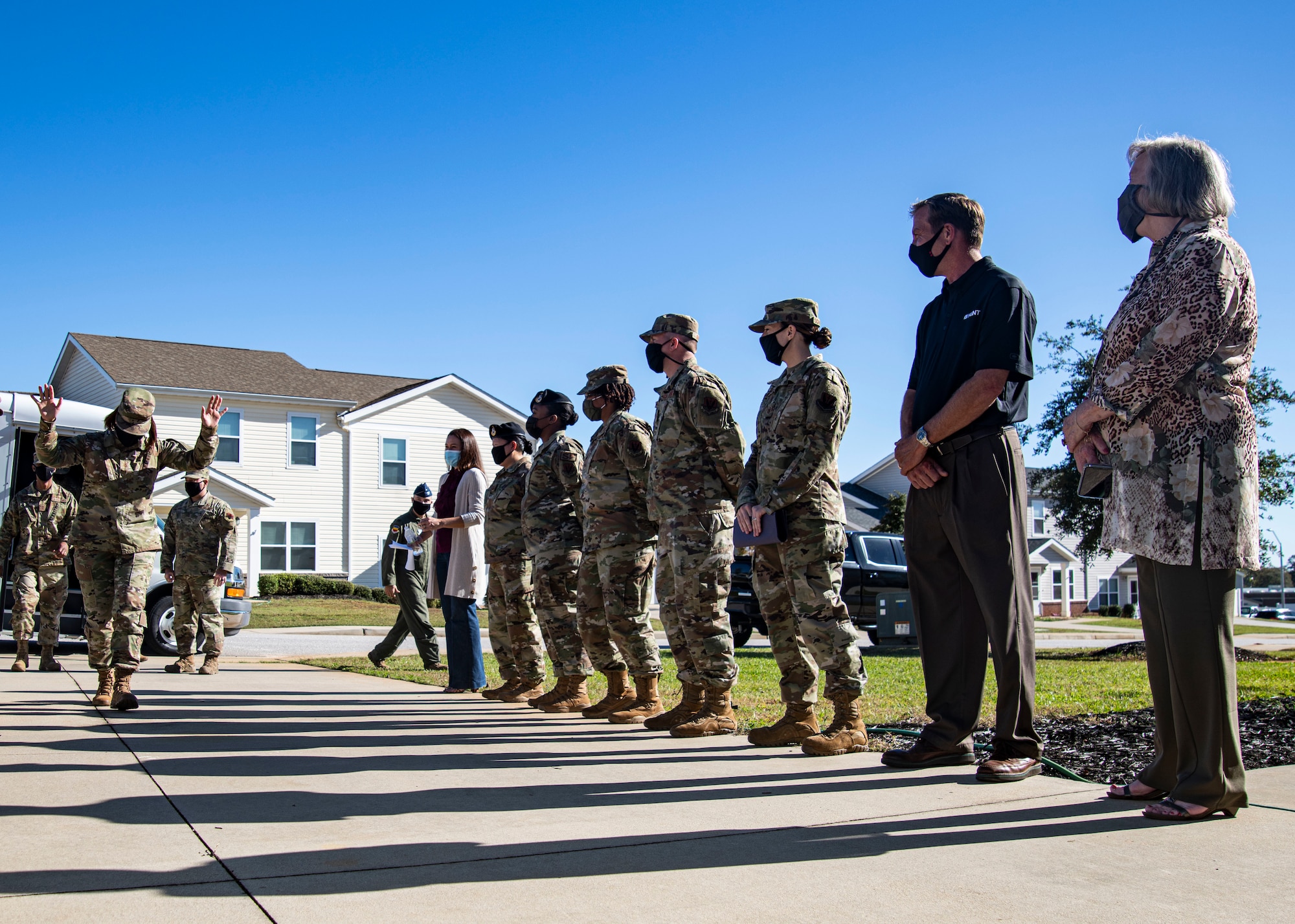 A photo of Airmen standing outside.