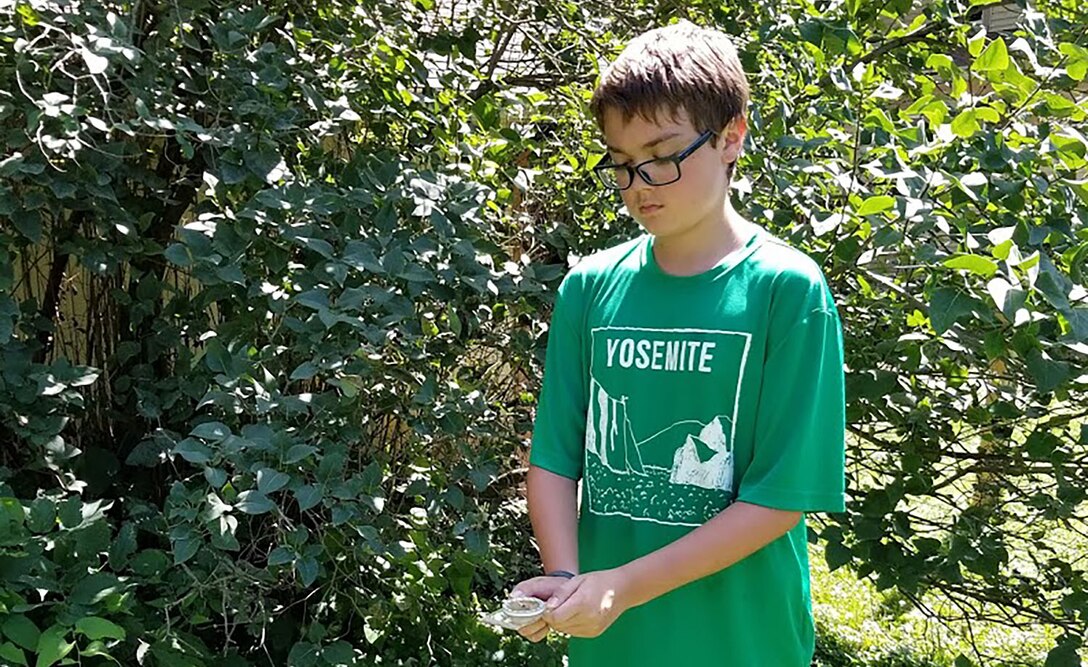 Boy using compass