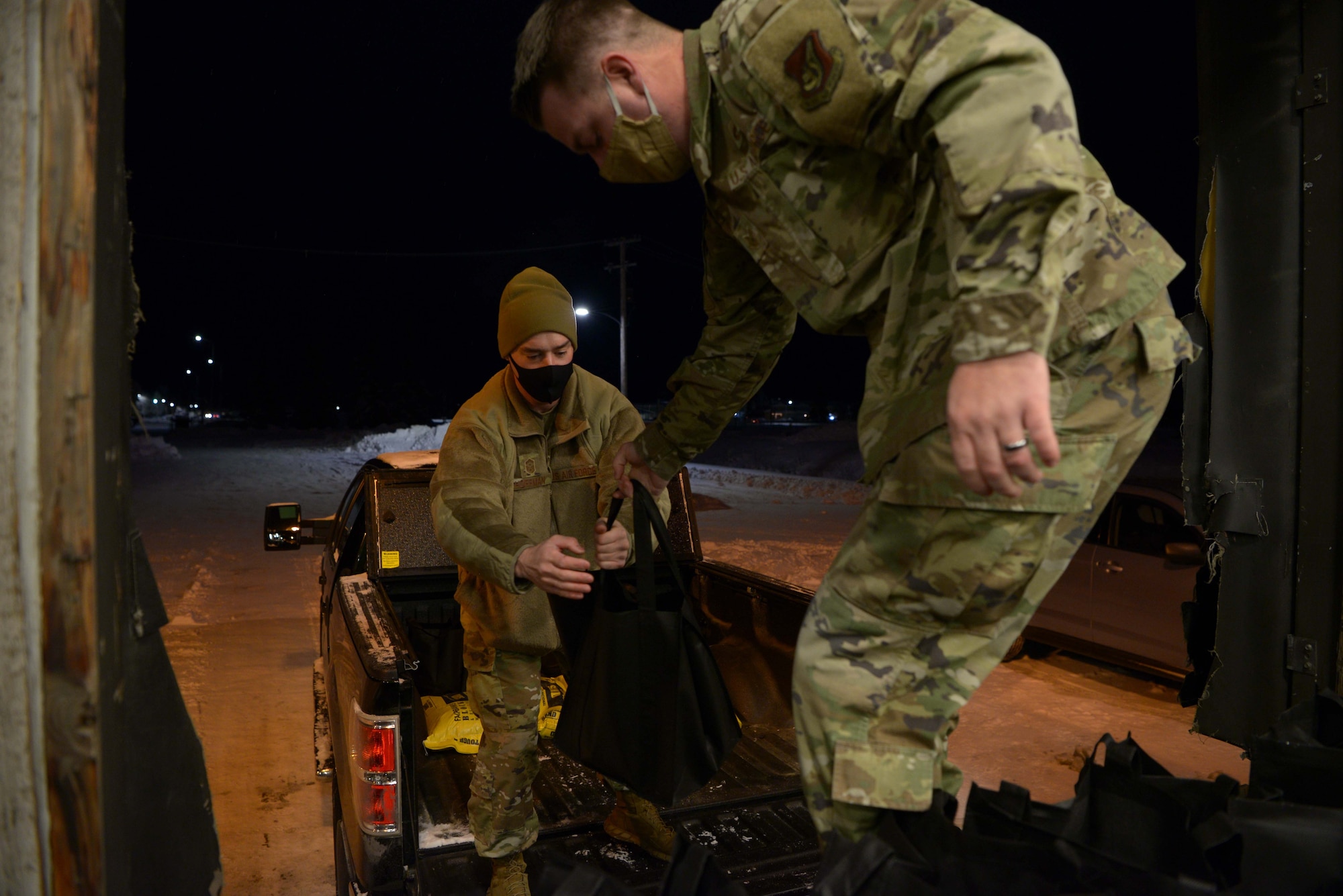 First Sergeants from the 354th Fighter Wing prepare to deliver packages for OPERATION Turkey Drop on Eielson Air Force Base, Alaska, Nov. 13, 2020. Once assembled and loaded, the First Sergeants distributed the packages to young Air Force families around the base. (U.S. Air Force photo by Senior Airman Beaux Hebert)