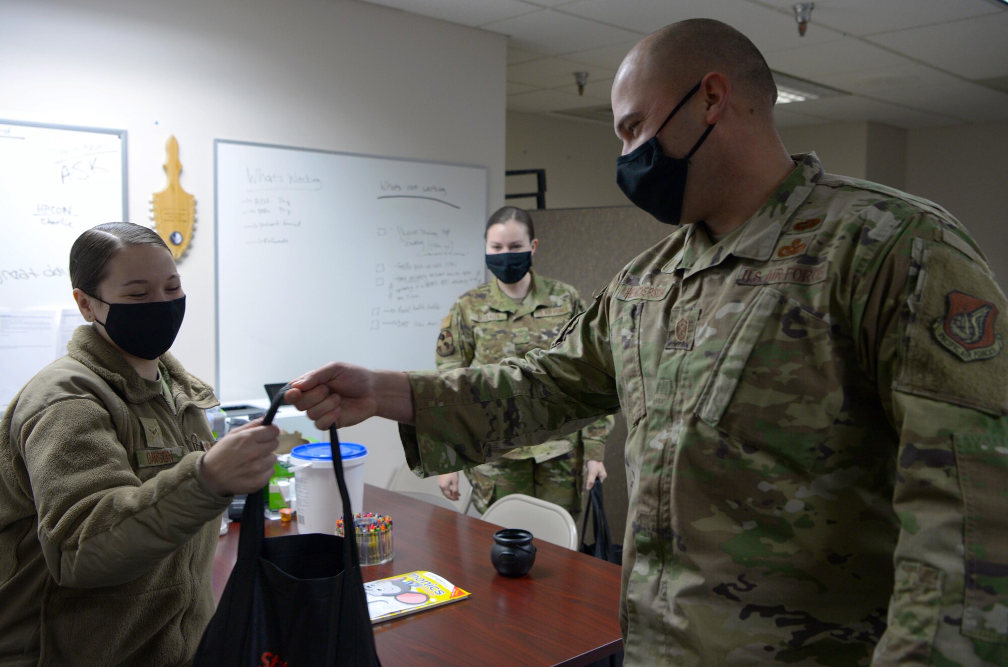 U.S. Air Force Master Sgt. Dwain Henderson, the 354th Medical Group first sergeant, delivers a package to an Airman as part of OPERATION Turkey Drop on Eielson Air Force Base, Alaska, Nov. 13, 2020. In total, 283 turkeys were delivered to young Airmen across Eielson. (U.S. Air Force photo by Senior Airman Beaux Hebert)