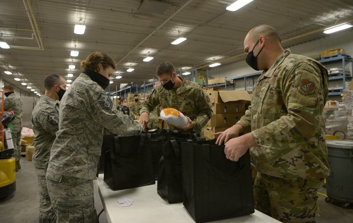 First Sergeants from the 354th Fighter Wing assemble packages for OPERATION Turkey Drop on Eielson Air Force Base, Alaska, Nov. 13, 2020. OPERATION Turkey Drop is an event that aims to give Air Force families a turkey and some fix-ins for their Thanksgiving meal. (U.S. Air Force photo by Senior Airman Beaux Hebert)
