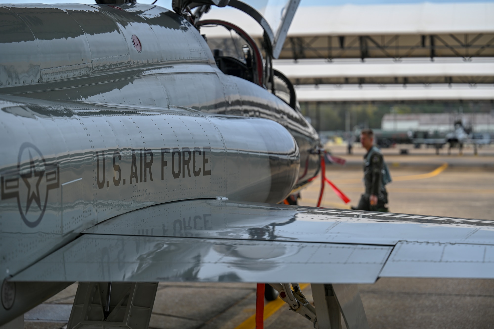 U.S. Air Force 1st Lt. Jared Rackers, 49th FTS Introduction to Fighter Fundamentals graduate, walks in front of a T-38 Talon Nov. 11, 2020, on Columbus Air Force Base, Miss. The T-38 is a two-seat trainer jet used by student pilots selected for the fighter track in pilot training. (U.S. Air Force photo by Airman 1st Class Davis Donaldson)