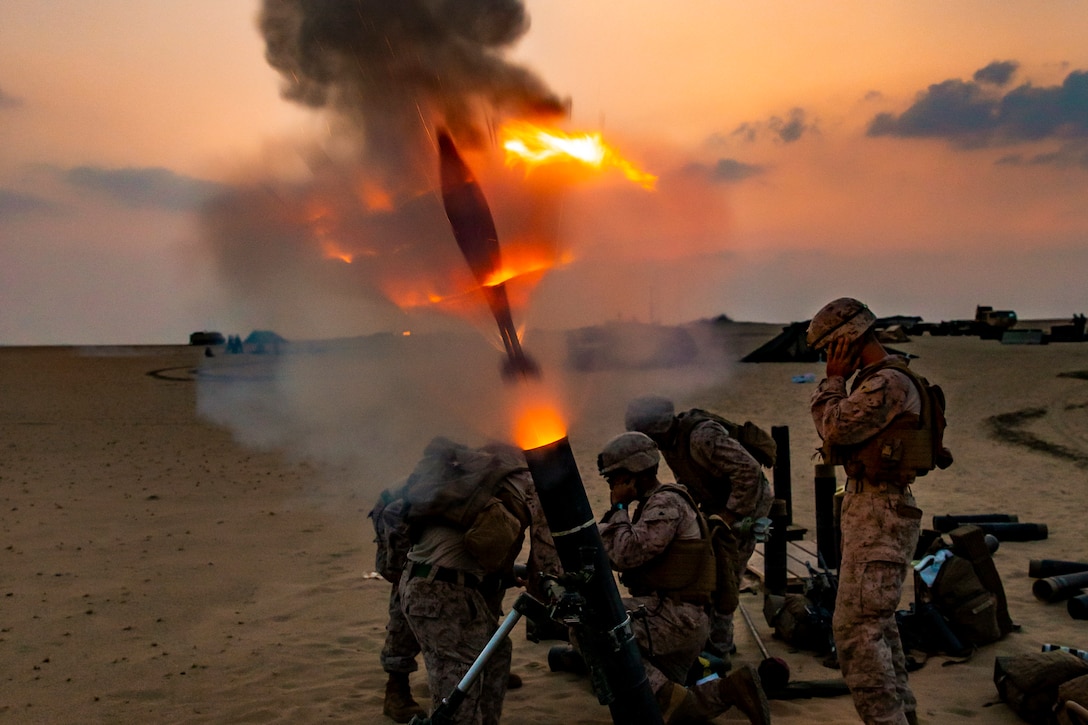 Marines fire a weapon.