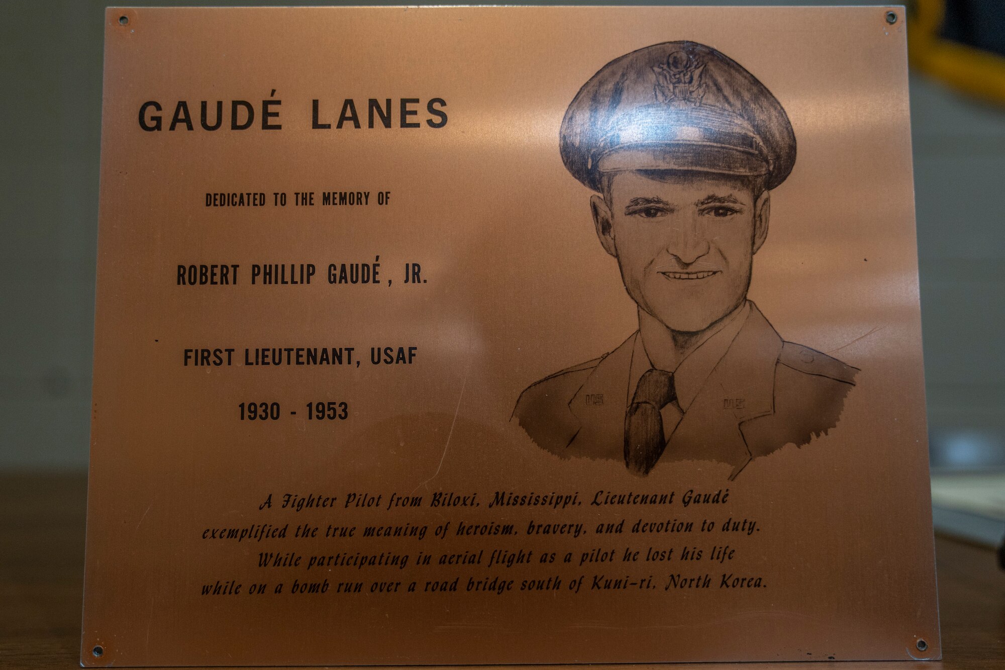 A plaque honoring 1st Lt. Robert P. Gaudé, Jr., 430th Fighter Bomber Squadron pilot, is displayed inside Gaudé Lanes Bowling Center at Keesler Air Force Base, Mississippi, Nov. 13, 2020. The bowling center was dedicated to Gaudé, who was killed in action during the Korean War on July 10, 1953. (U.S. Air Force photo by Airman 1st Class Kimberly L. Mueller)
