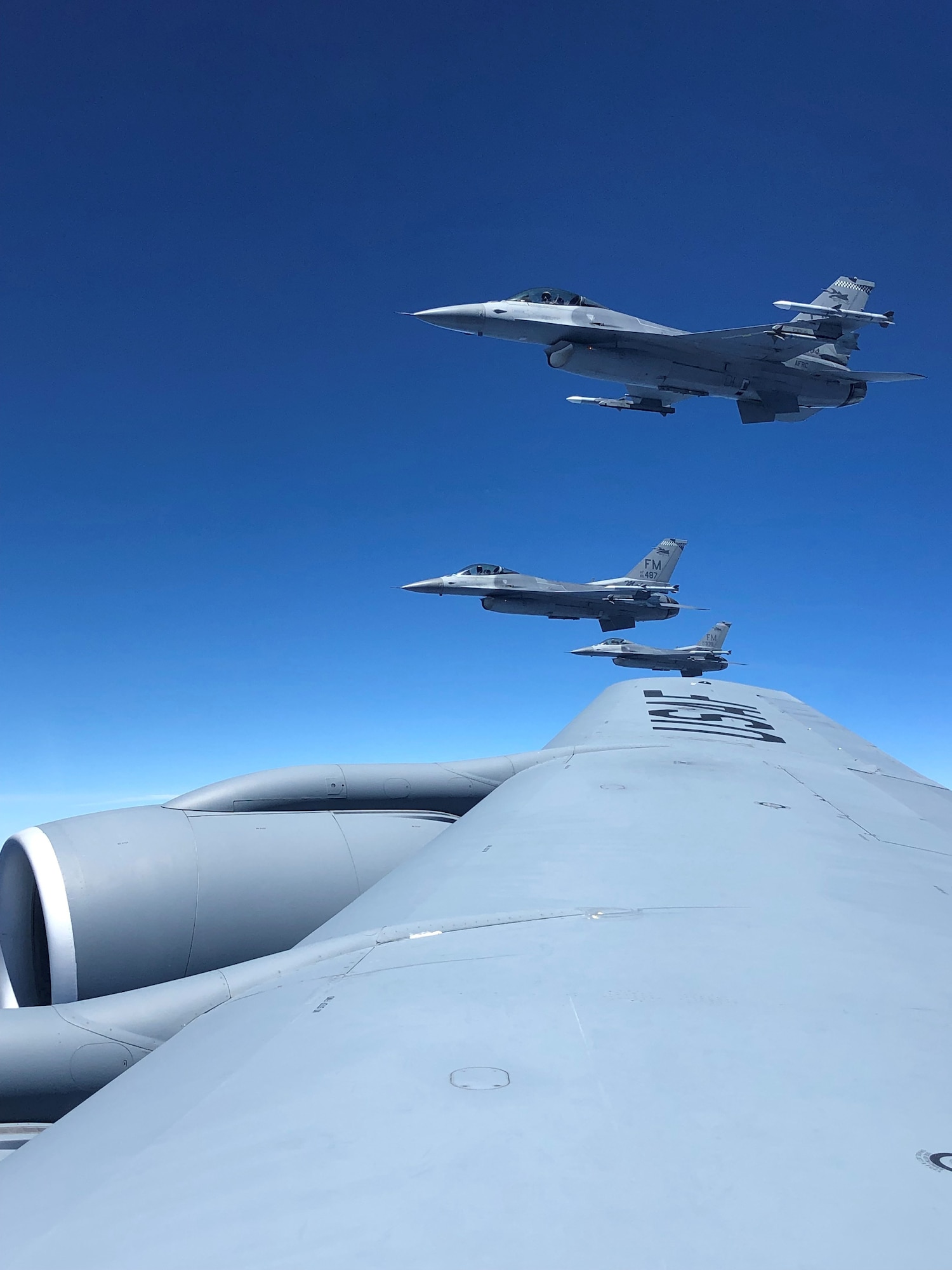 Three F-16 Fighting Falcon aircraft assigned to Homestead Air Reserve Base, Fla., fly in formation alongside the  wing of a KC-135 Stratotanker from MacDill Air Force Base, Fla., prior to an in-flight refueling, Apr. 15, 2019.