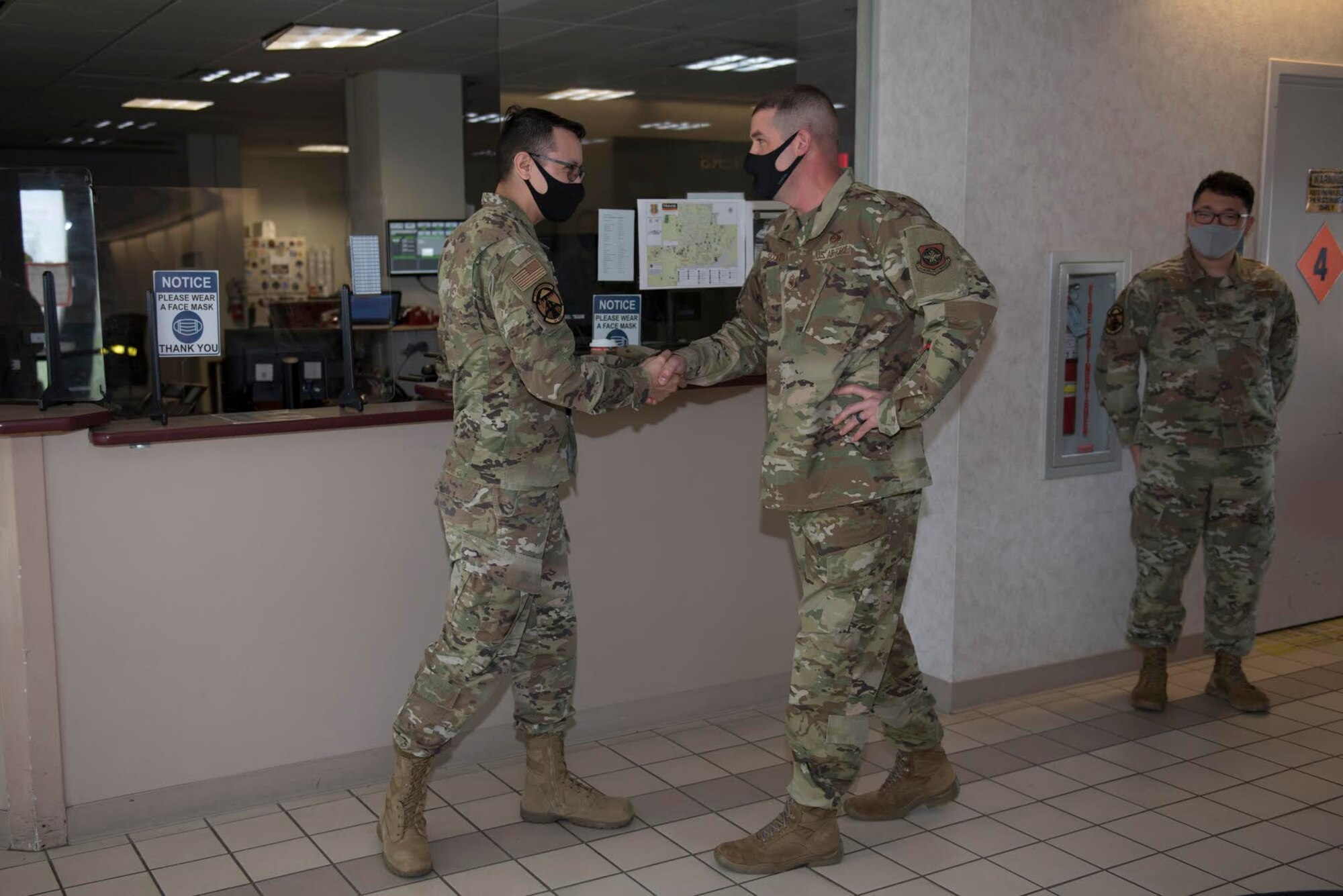 U.S. Air Force Chief Master Sgt. Stephen Scofield, right, 60th Maintenance Squadron superintendent, recognizes Tech. Sgt. Michael Ober, 60th Operations Support Squadron airfield manager, as a star performer during Leadership Rounds Nov. 20, 2020, at Travis Air Force Base, California. The Leadership Rounds program provides 60th Air Mobility Wing leadership an opportunity to interact with Airmen and receive a detailed view of each mission performed at Travis AFB. (U.S. Air Force photo by Senior Airman Cameron Otte)