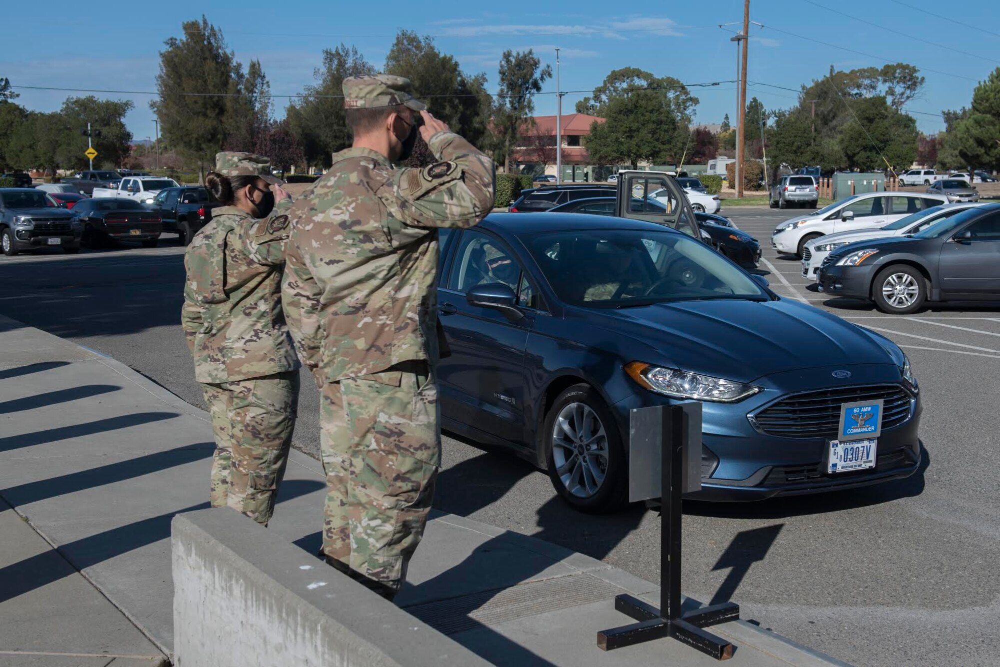 U.S. Air Force Chief Master Sgt. Jesenia Ortiz, left, 60th Operations Support Squadron superintendent, and Lt. Col. Nathan Padgett, 60th OSS commander, salute as Col. Corey Simmons, 60th Air Mobility Wing commander, and Chief Master Sgt. Stephen Scofield, 60th Maintenance Squadron superintendent, arrive at the Base Operations building for Leadership Rounds Nov. 20, 2020, at Travis Air Force Base, California. The Leadership Rounds program provides 60th AMW leadership an opportunity to interact with Airmen and receive a detailed view of each mission performed at Travis AFB. (U.S. Air Force photo by Senior Airman Cameron Otte)