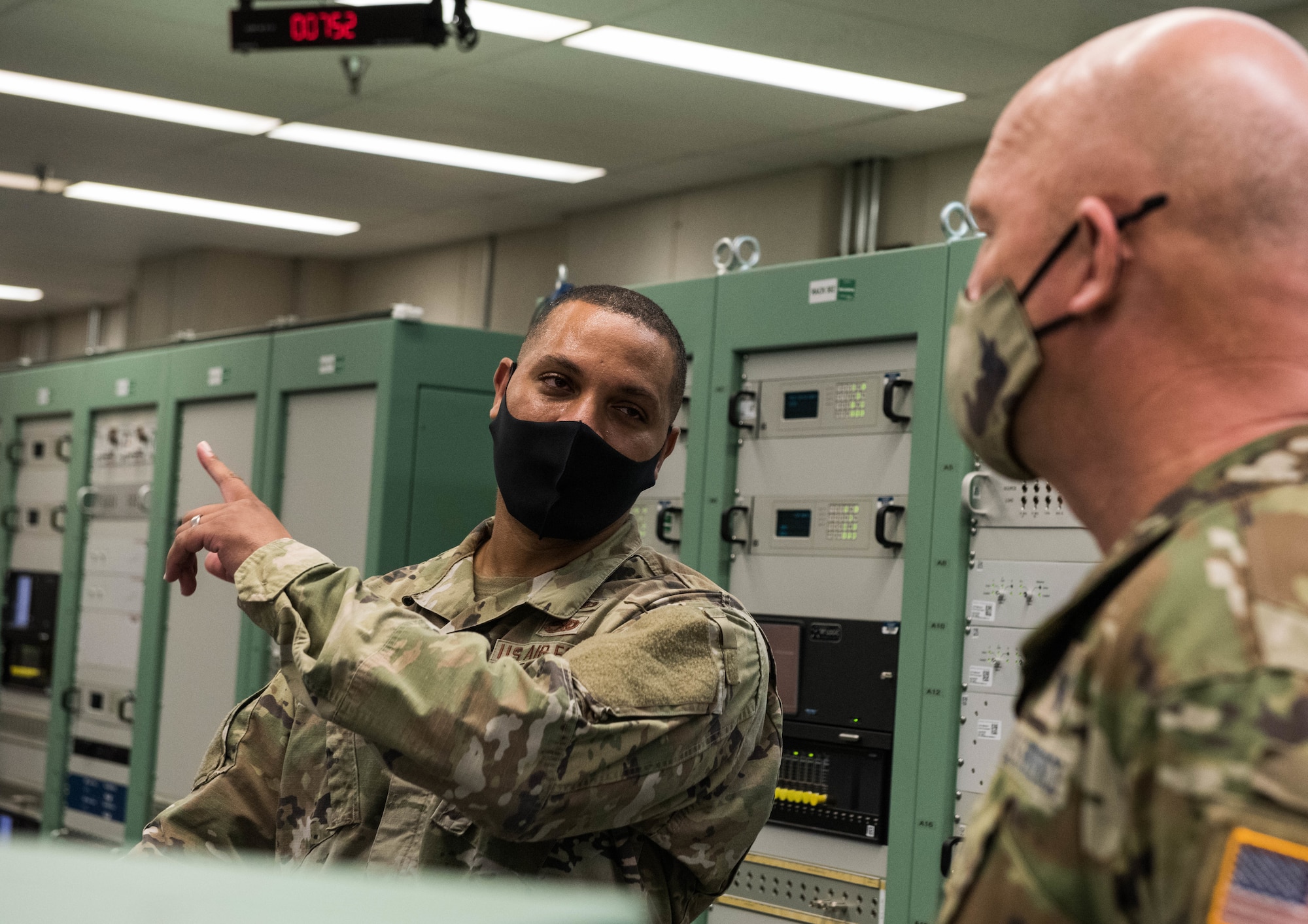 U.S. Space Force Gen. John W. "Jay" Raymond, right, Chief of Space Operations, receives a brief at the 21st Space Operations Squadron (SOS), Ka’ena Point, Oahu, Nov. 21, 2020. Ka’ena Point is part of the Air Force Satellite Control Network, which consists of seven remote tracking stations located around the world. Raymond visited the 21st SOS detachment during his first official visit to Pacific Air Forces Headquarters at Joint Base Pearl Harbor-Hickam, Hawaii. (U.S. Air Force photo by Staff Sgt. Hailey Haux)