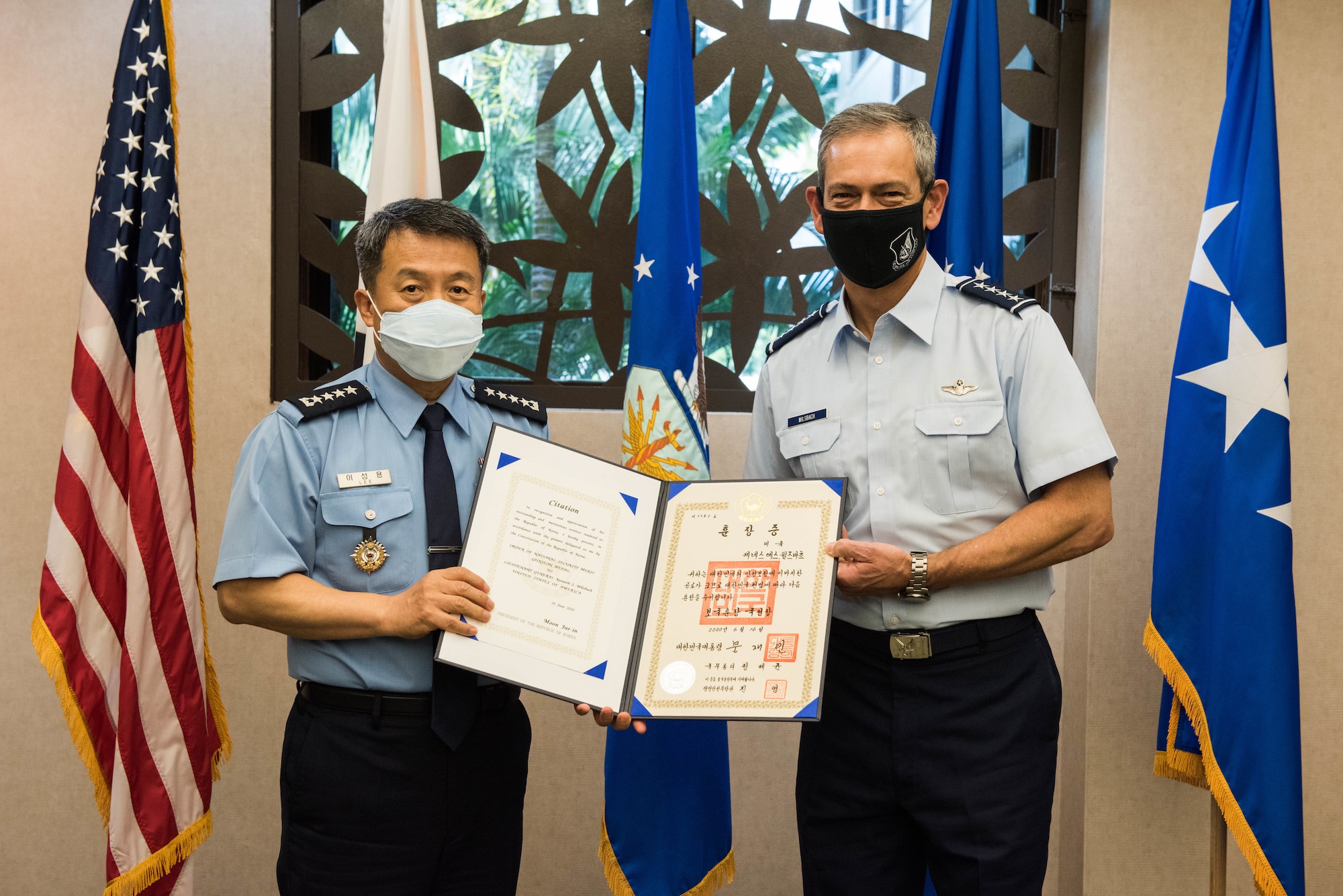 U.S. Air Force Gen. Ken Wilsbach, Pacific Air Forces (PACAF) commander, receives the Order of National Security Merit Gukseon Medal from Gen. Lee Seong Yong, Chief of Staff Republic of Korea Air Force (ROKAF), during a visit to PACAF Headquarters on Joint Base Pearl Harbor-Hickam, Hawaii, Nov. 19, 2020. Wilsbach was awarded the medal in recognition of his distinguished service as the commander of the 7th Air Force and contribution to the security on the Korean Peninsula. (U.S. Air Force photo by Staff Sgt. Hailey Haux)