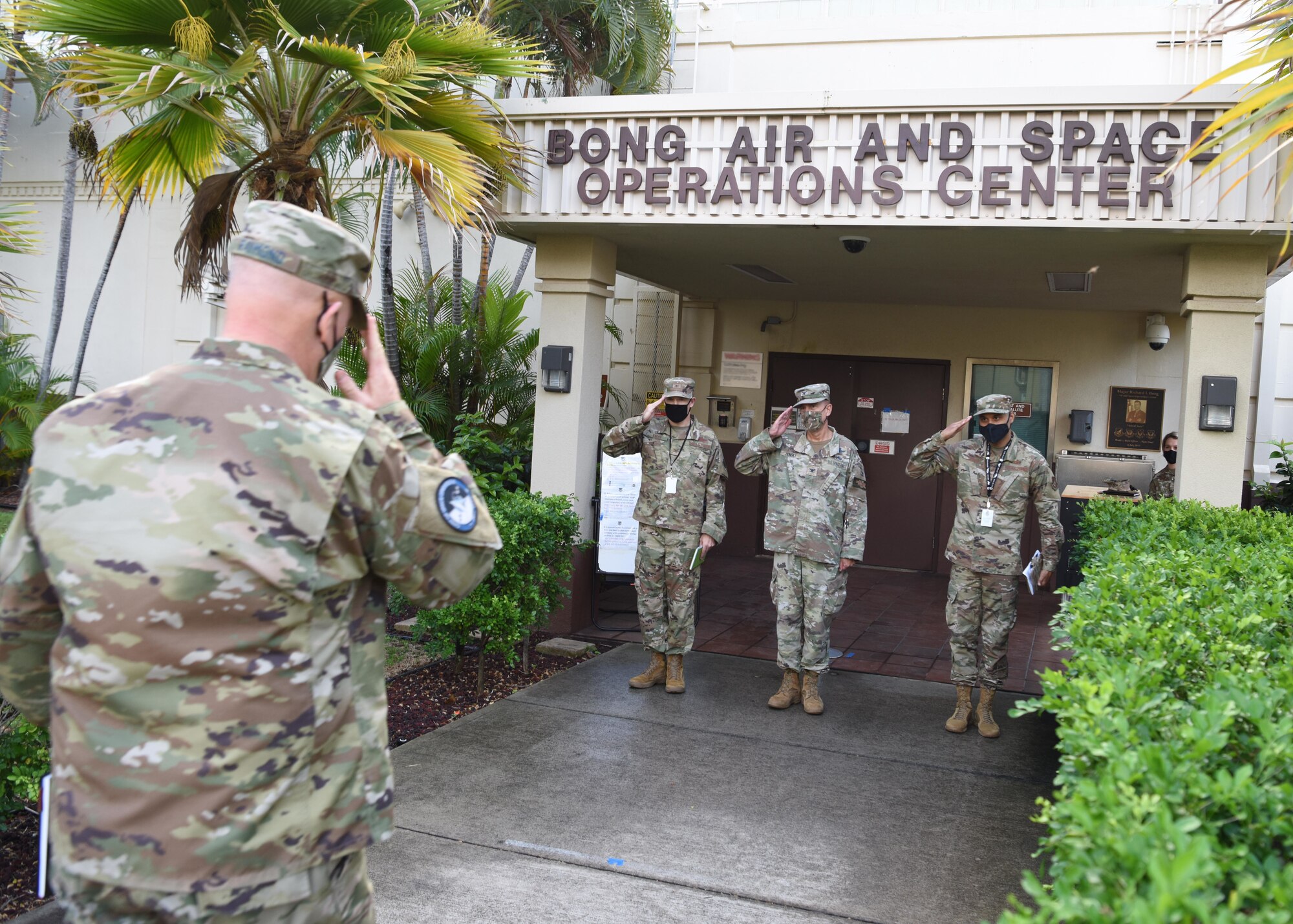 U.S. Space Force Gen. John W. “Jay” Raymond, Chief of Space Operations, returns a salute to U.S. Air Force Col. Nicholas Evans, 613th Air Operations Center (AOC) commander, U.S. Space Force Col. Anthony Zilinsky, Pacific Air Forces Director of Space Forces and Chief Master Sgt. Reuben Jones, 613th AOC Chief Enlisted Manager, at Joint Base Pearl Harbor-Hickam, Hawaii, Nov. 20, 2020. Raymond visited space professionals working at the 613th AOC to gain first-hand insight into their daily operations. (U.S. Air Force illustration by Tech. Sgt. Zach Vaughn)