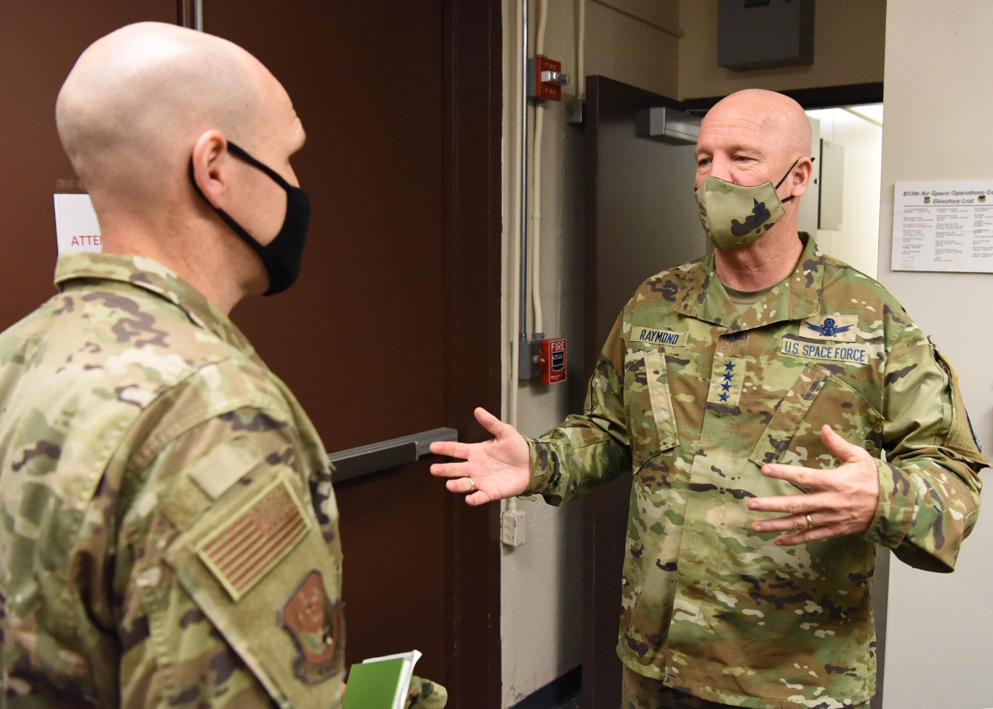 U.S. Space Force Gen. John W. “Jay” Raymond, Chief of Space Operations, talks with U.S. Air Force Col. Nicholas Evans, 613th Air Operations Center commander, at Joint Base Pearl Harbor-Hickam, Hawaii, Nov. 20, 2020. Raymond visited space professionals working at the 613th AOC to gain first-hand insight into their daily operations. (U.S. Air Force illustration by Tech. Sgt. Zach Vaughn)