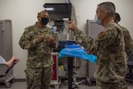 U.S. Air Force Maj. Gen. John J. DeGoes, 59th Medical Wing commander, speaks with U.S. Army Brig. Gen. Shan K. Bagby, Brooke Army Medical Center commanding general, about medical simulation training, Nov. 23, 2020, in the 59th Medical Wing Medical Simulation Center, Wilford Hall Ambulatory Surgical Center, Joint Base San Antonio-Lackland, Texas.