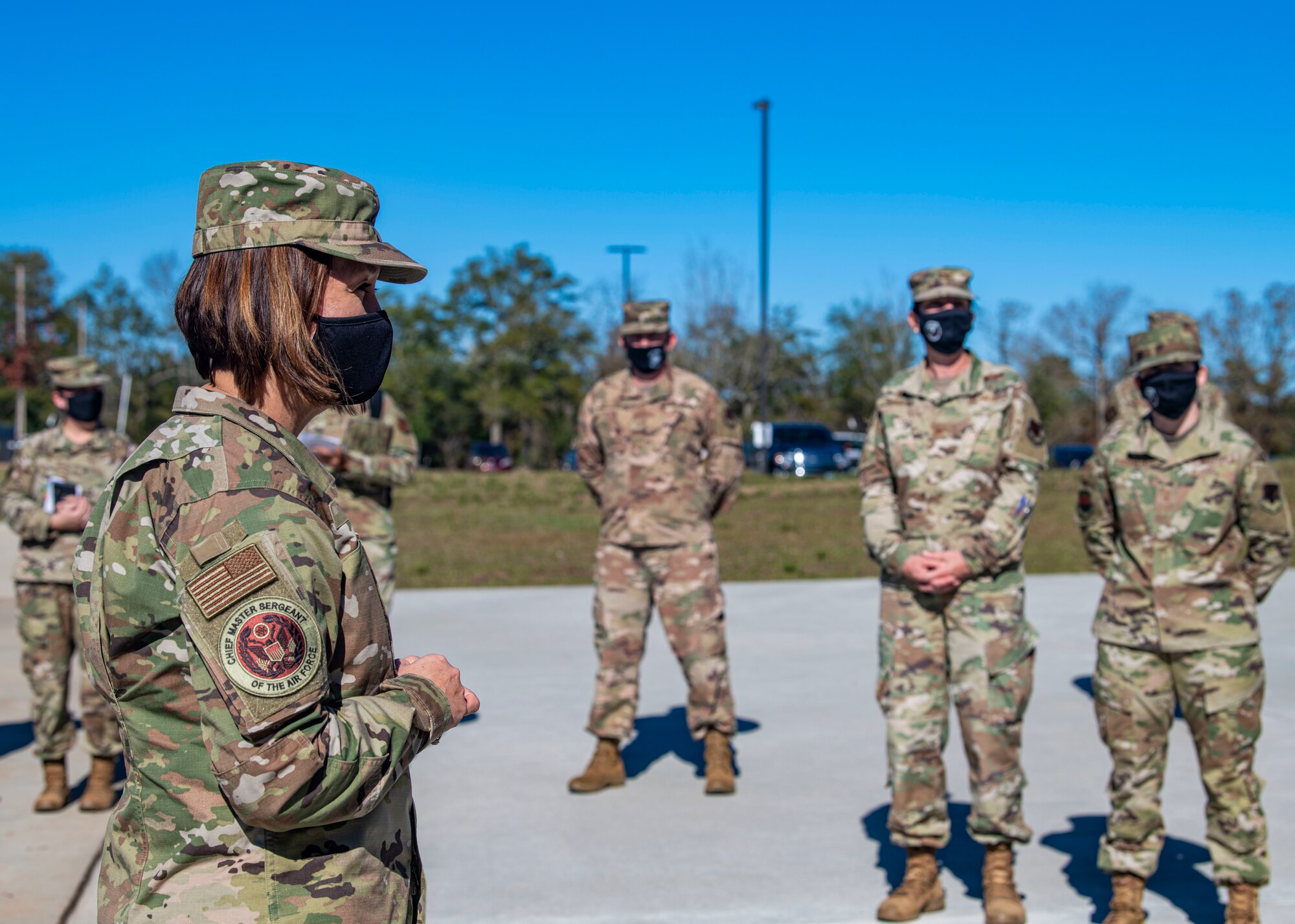 A photo of Airmen standing outside.