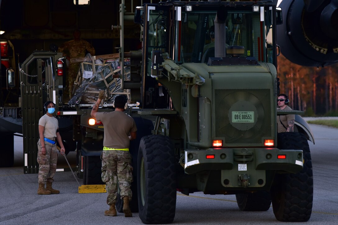 Airmen assigned to the 628th Air Base Wing begin to offload cargo from a C-17 Globemaster III at McEntire Joint National Guard Base, S.C., Nov. 16, 2020. Palmetto Challenge is a global mobilization exercise held at McEntire Joint National Guard Base, S.C. The exercise is held in order to develop readiness and awareness in a simulated deployed environment for over 100 Airmen from Joint Base Charleston.