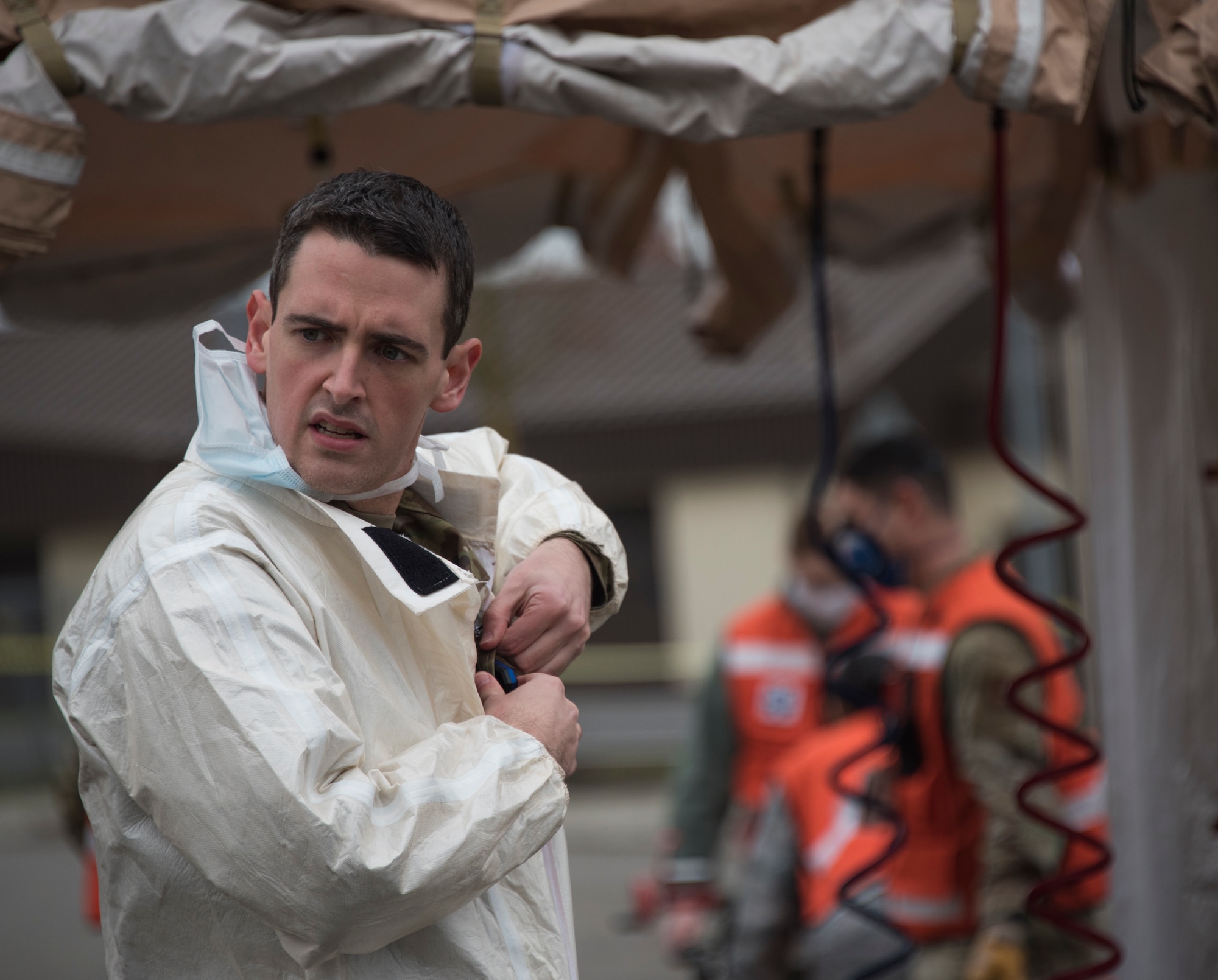 U.S. Air Force Capt. Prescott McWilliams, 52nd Medical Group acting in-place patient decontamination team chief, prepares to receive mock patients who may have been exposed to simulated airborne substances during an exercise at Spangdahlem Air Base, Germany, Nov. 17, 2020. The in-place decontamination tents exercised the steps that would be taken in a real world scenario, to ensure any possible contamination wouldn't spread to the medical facility. (U.S. Air Force photo by Senior Airman Chanceler Nardone)