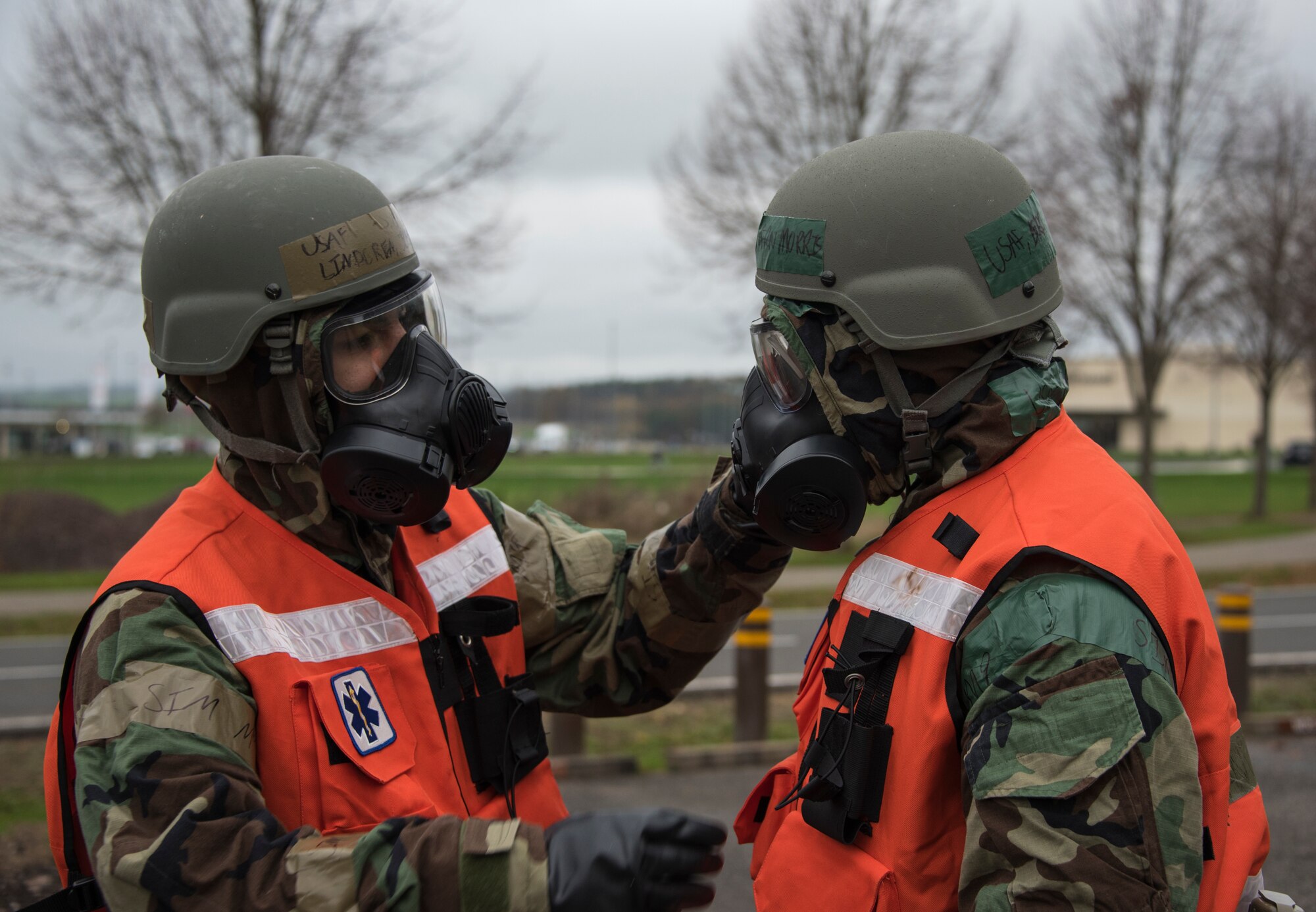 U.S. Air Force Staff Sgt. Joseph Lindgren, left, and Senior Airman Trevern Morris, right, 52nd Medical Group dental technicians, perform "buddy checks" during an exercise at Spangdahlem Air Base, Germany, Nov. 17, 2020. "Buddy checks" help ensure personnel are protected from any potentially harmful airborne substances.  (U.S. Air Force photo by Senior Airman Chanceler Nardone)