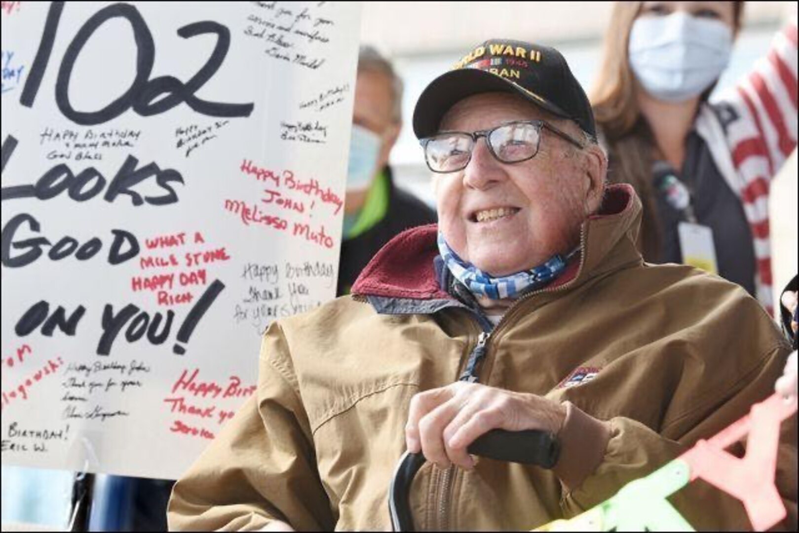 Retired Lt. Col. John Mahler, who was once assigned to the 342nd Bombardment Squadron, celebrates his 102nd birthday as he watches a parade of military and first responder vehicles pass the Butler Veterans Affairs Health Care Wellness Center on Nov. 12, 2020, in Butler, Pa.