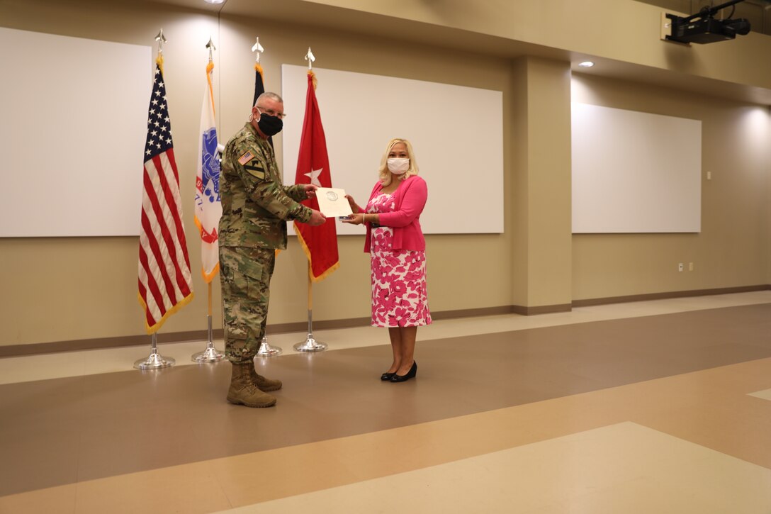 U.S. Army Civil Affairs and Psychological Operations Command (Airborne) Commanding General, Brig. Gen. Jeffrey C. Coggin, presents the Federal Length of Service Award to Ivy J. Mata for 25 years of federal service during the Soldier and Department of the Army Civilian recognition award ceremony at USACAPOC(A) Headquarters, Fort Bragg, N.C., Nov. 17, 2020. The recognition award ceremony was held to recognize 12 USACAPOC(A) Soldiers and DA civilians for Federal Length of Service Awards, Honorary Awards, Retirement recognition, and military awards.